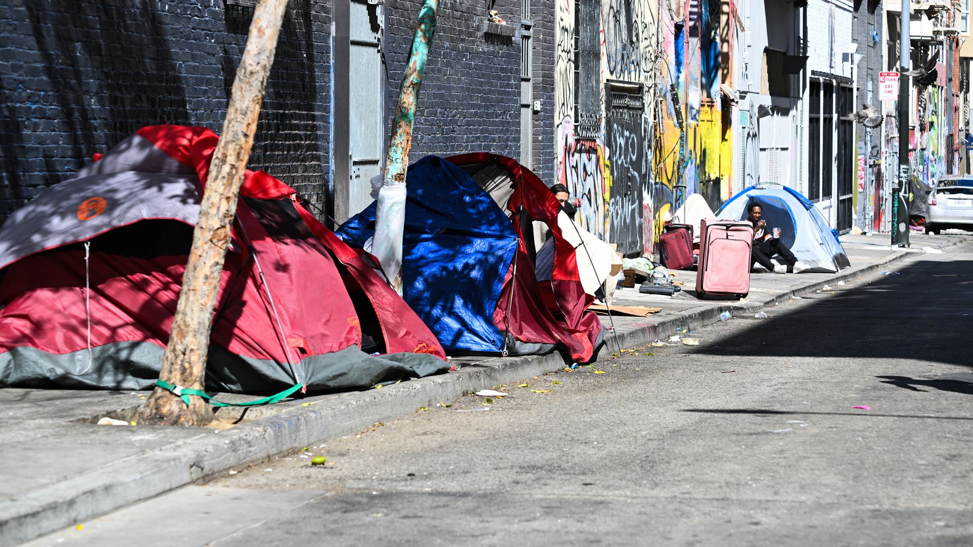 Photo of homeless tents lining a street sidewalk