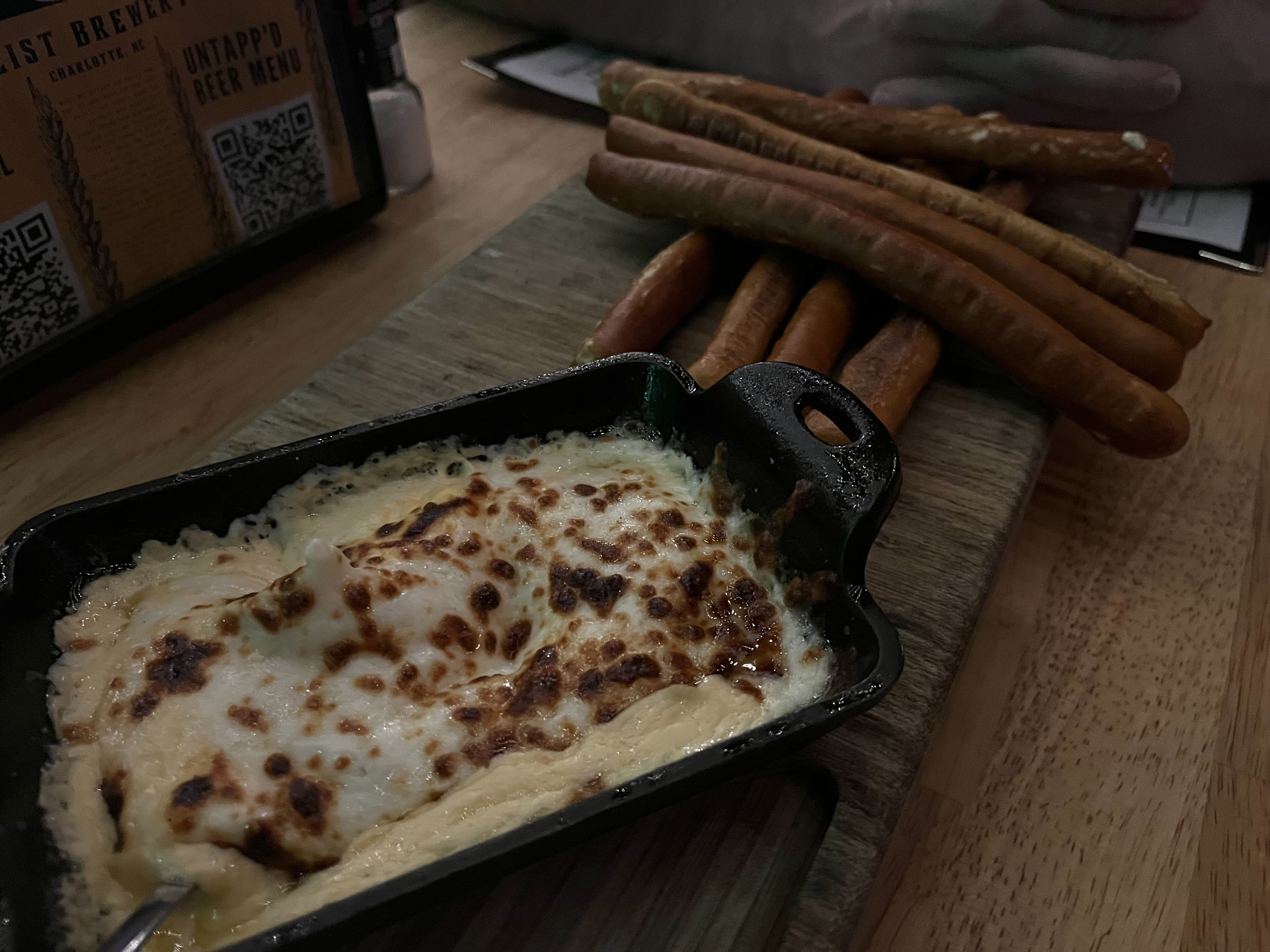 cheese in a skillet and hot dogs