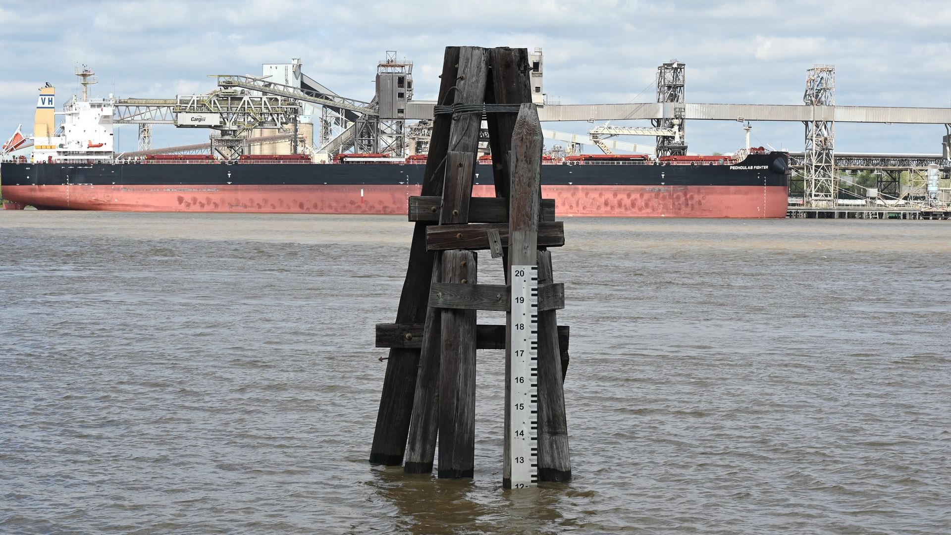 Photo shows a measuring stick in the river.