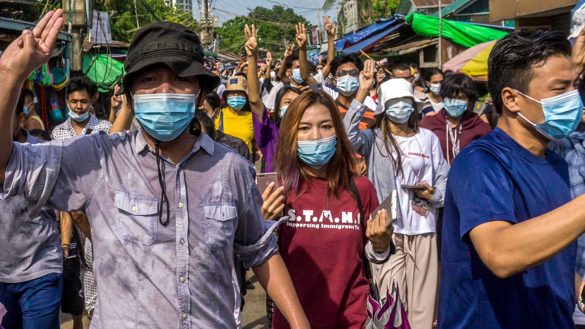 Protesters make the three-finger salute during a demonstration against the military coup in Yangon on May 15