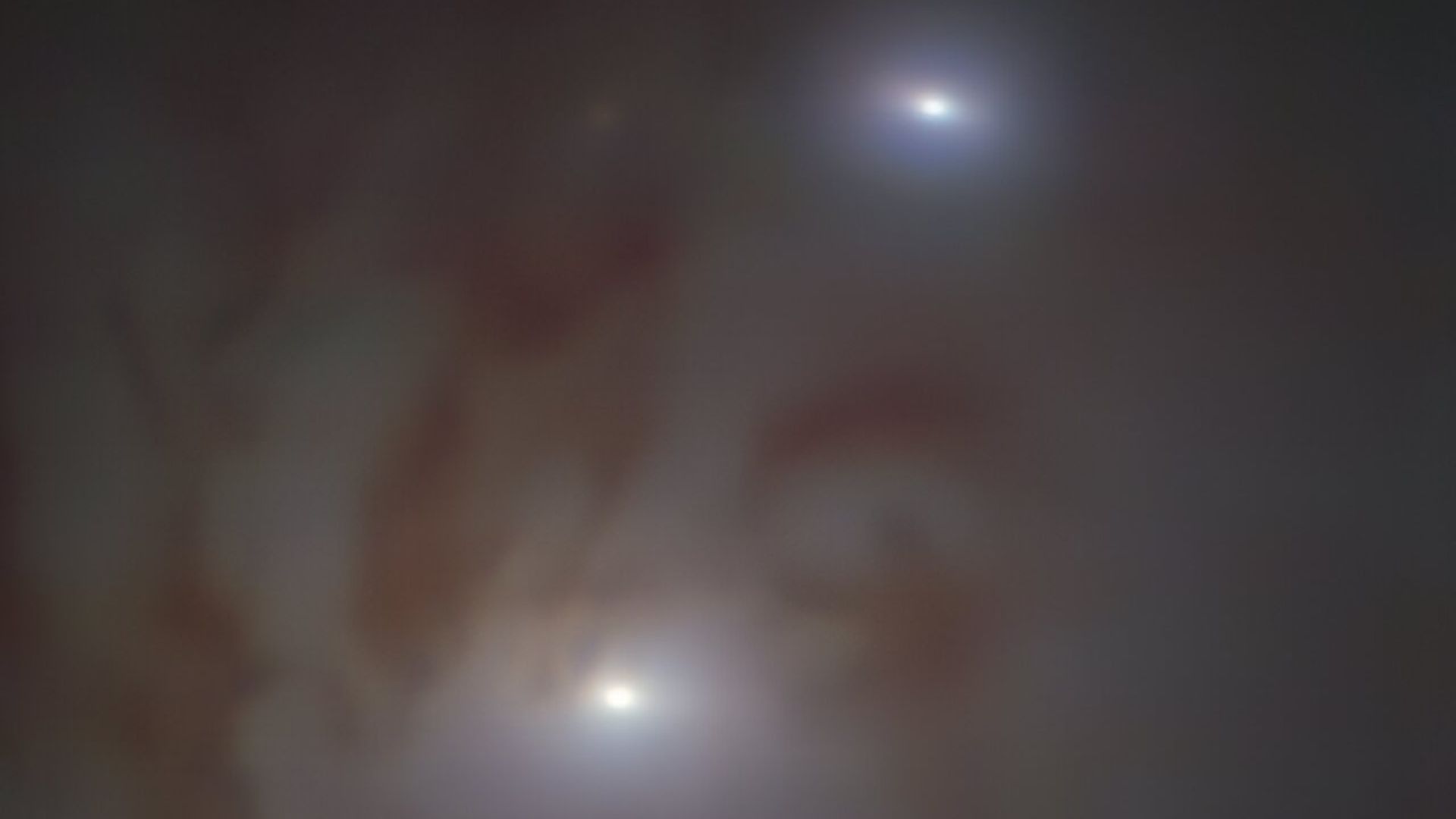Two black holes (bright, white dots) not far from one another, heading for a collision