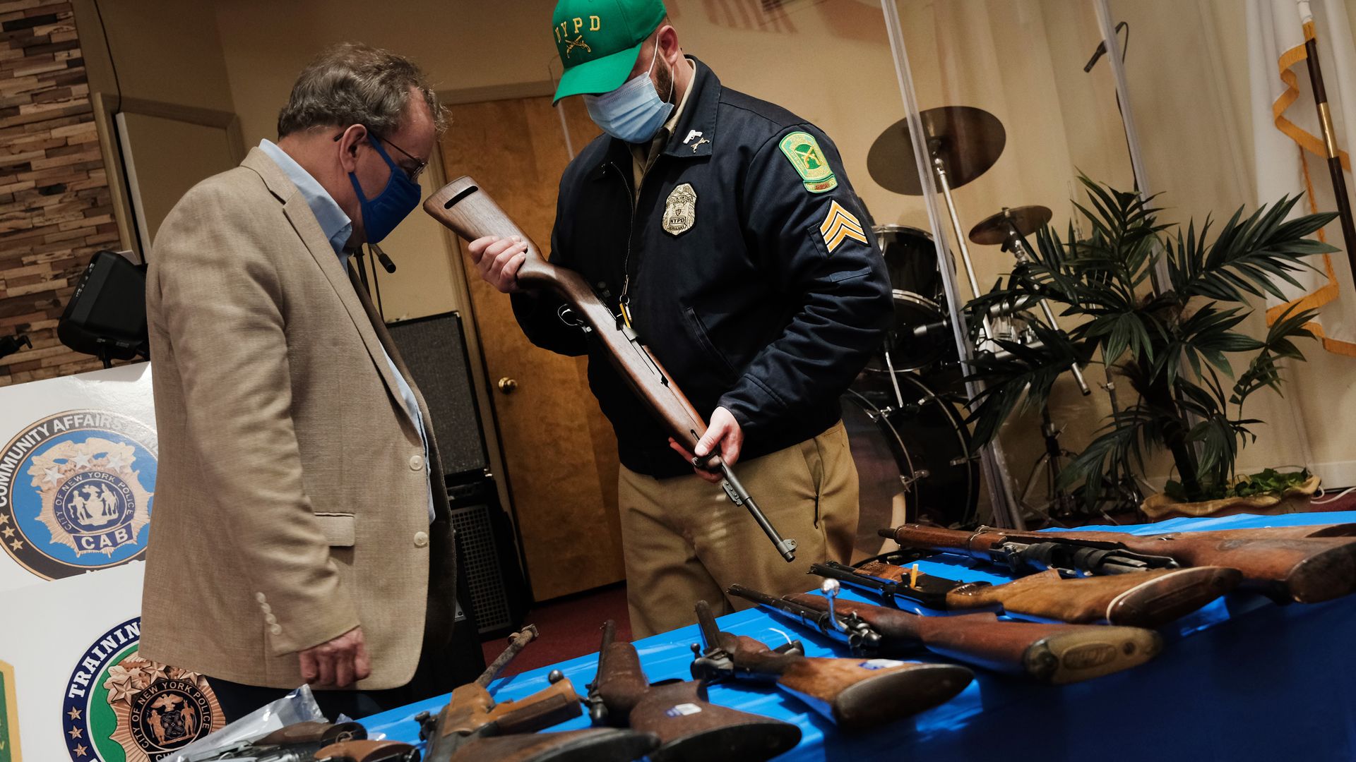 A police officer holds a gun at a gun buy-back event.