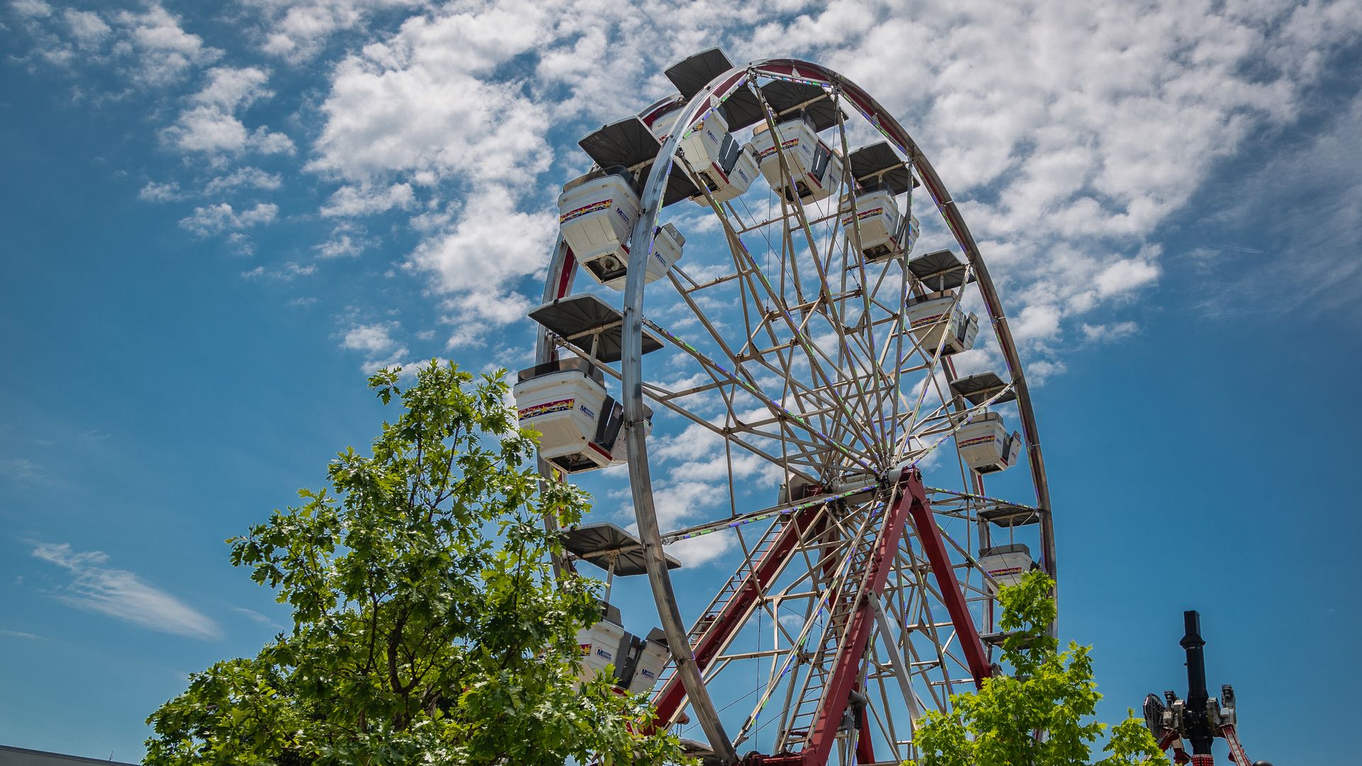A ferris wheel on a blue sky day.
