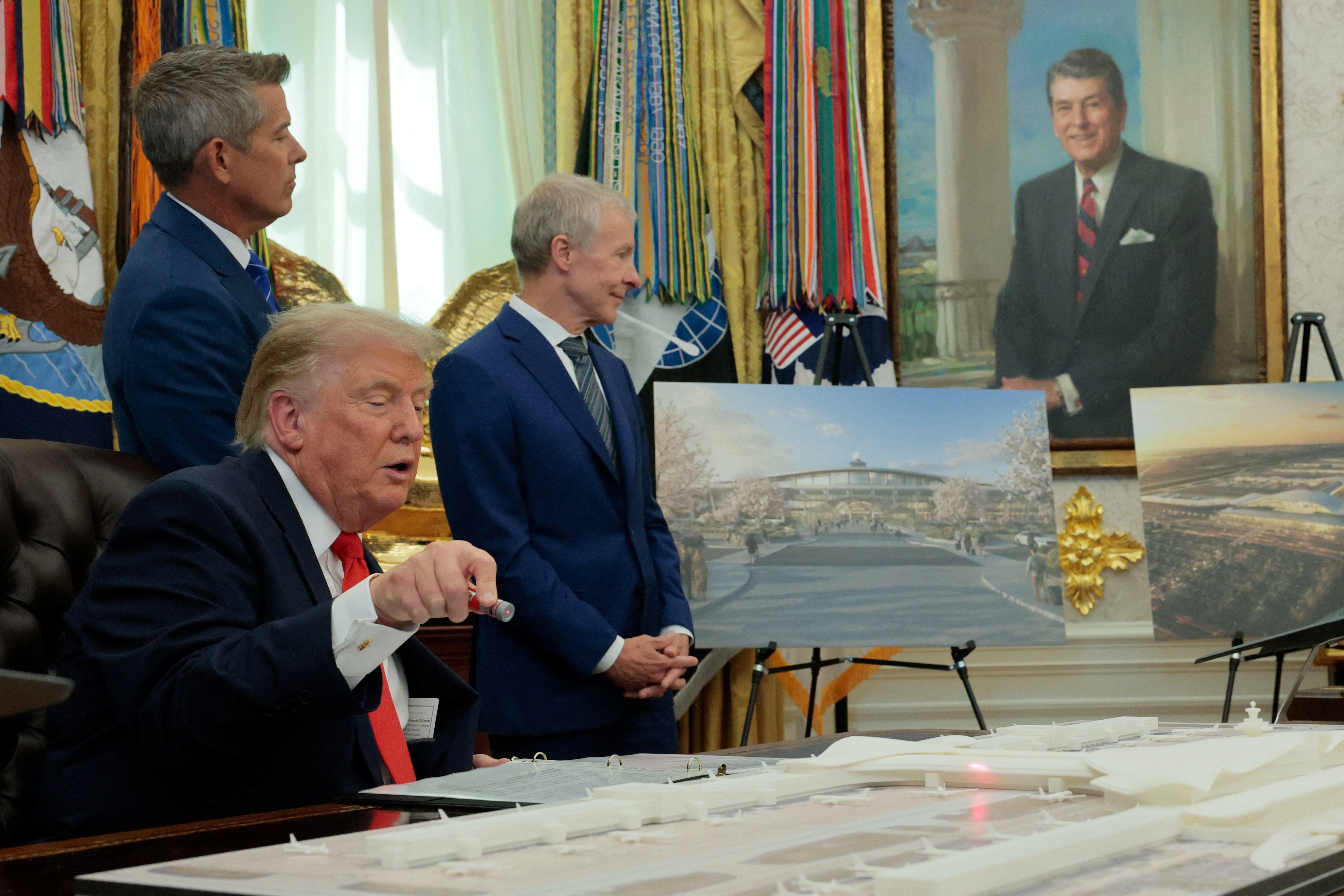 President Trump uses a laser pointer on an airport model while unveiling planned Dulles renovations last week.