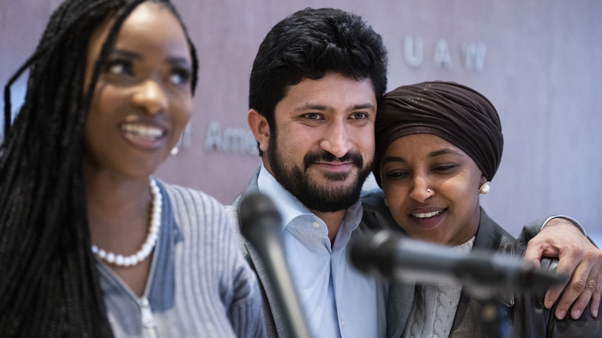 Reps. Greg Casar, wearing a light blue shirt, and Ilhan Omar, wearing a leather jacket, white sweater and brown headscarf.