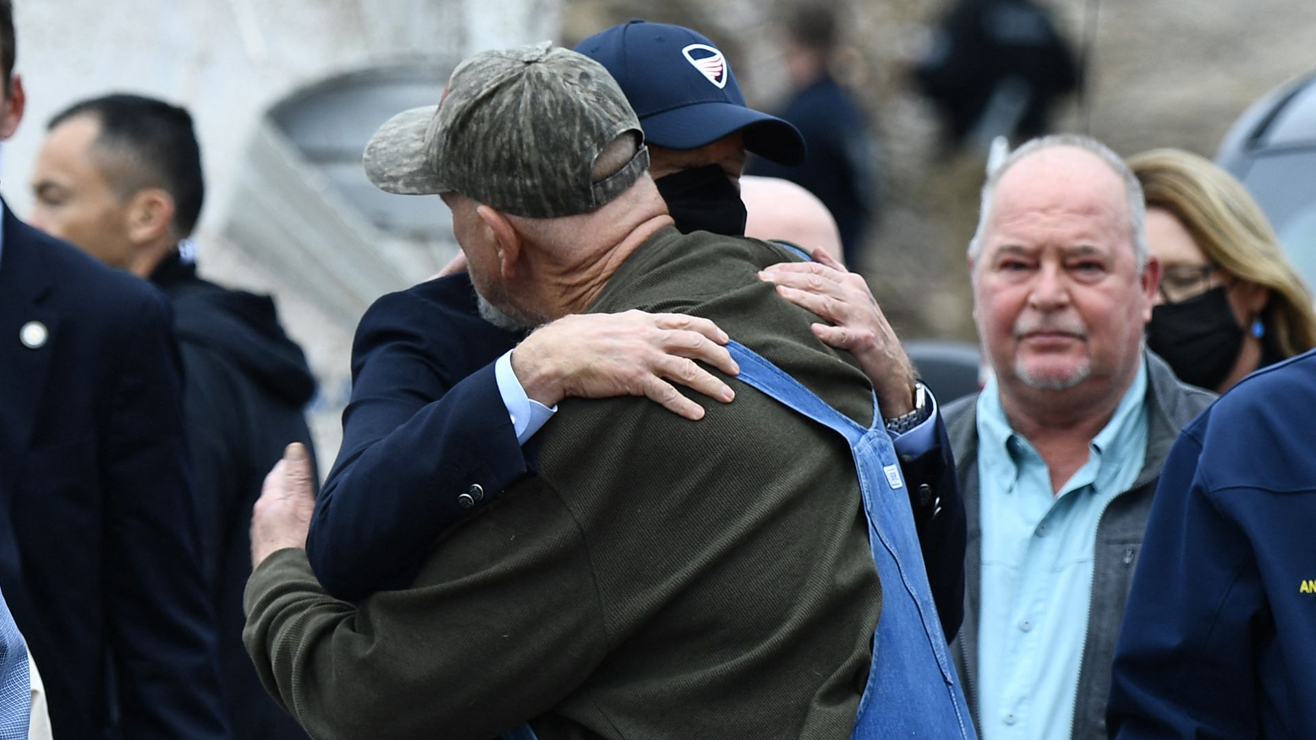 President Biden is seen hugging a resident of Mayfield, Ky., after touring tornado damage in the area.
