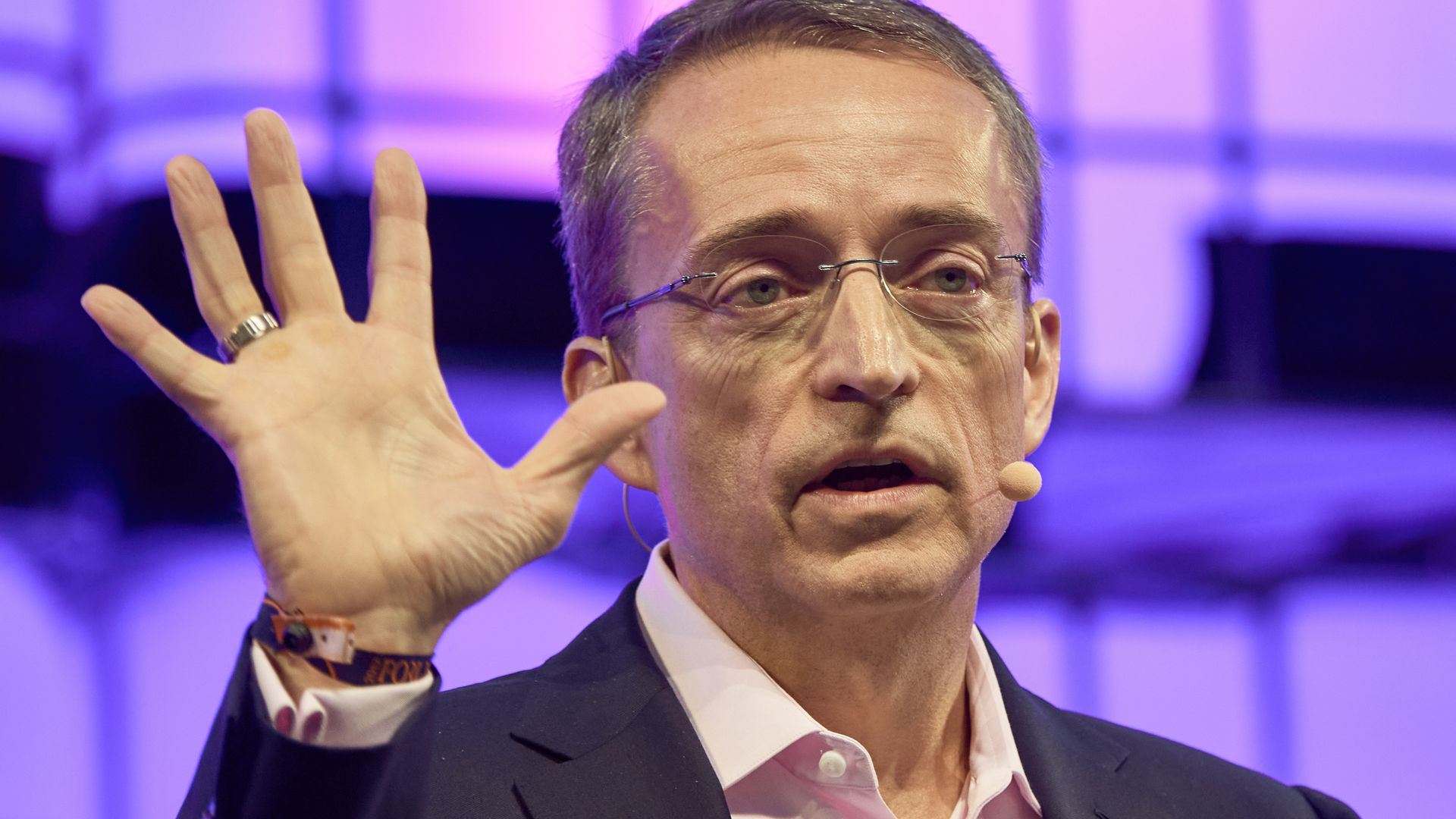 Intel CEO Pat Gelsinger holds up five fingers.