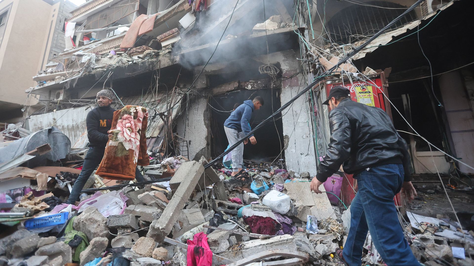 Palestinians inspect the destruction caused by air strikes on their homes in Khan Yunis in Gaza. 