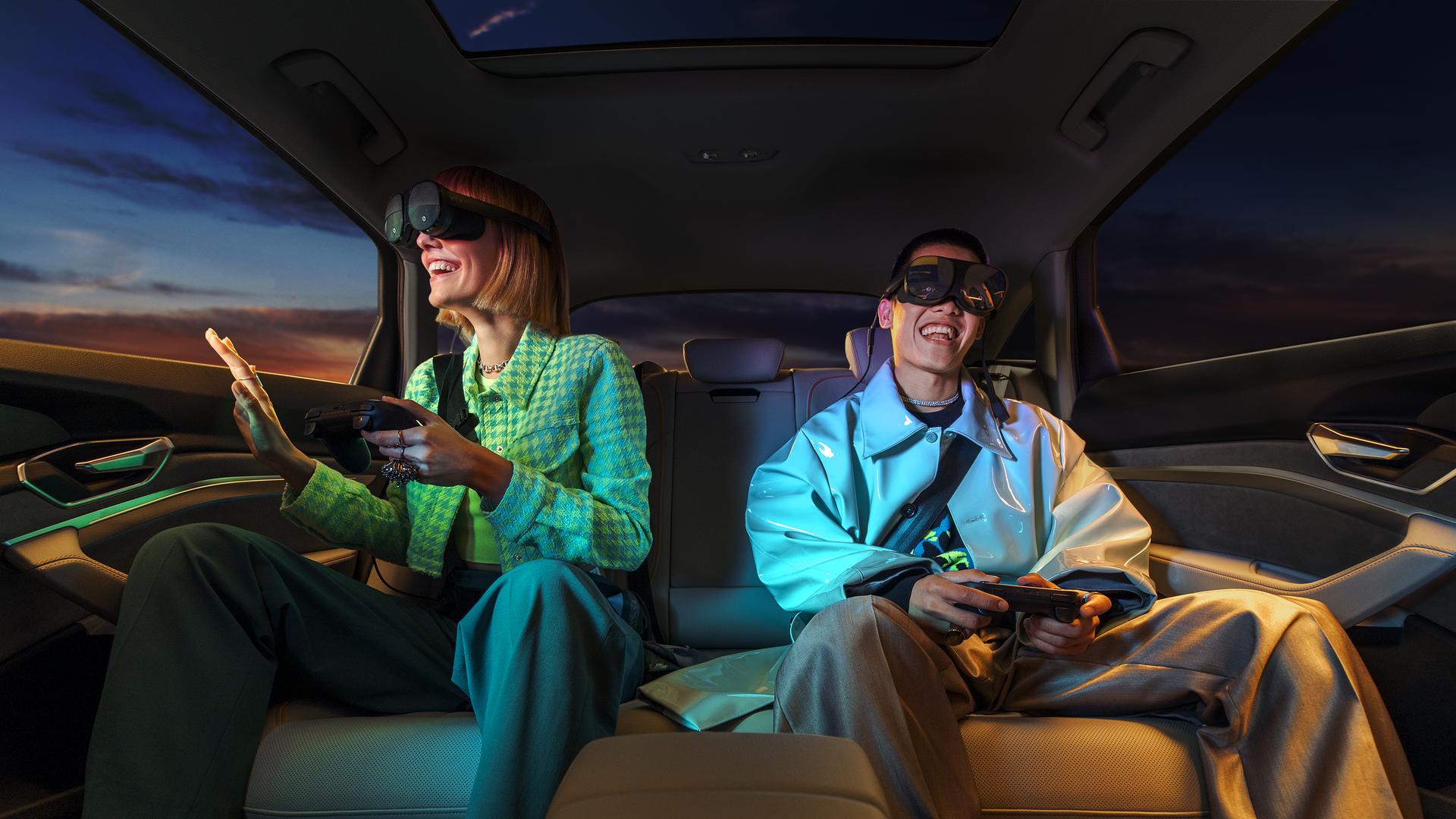 Image of a man and a woman in the back seat of a car wearing VR headsets