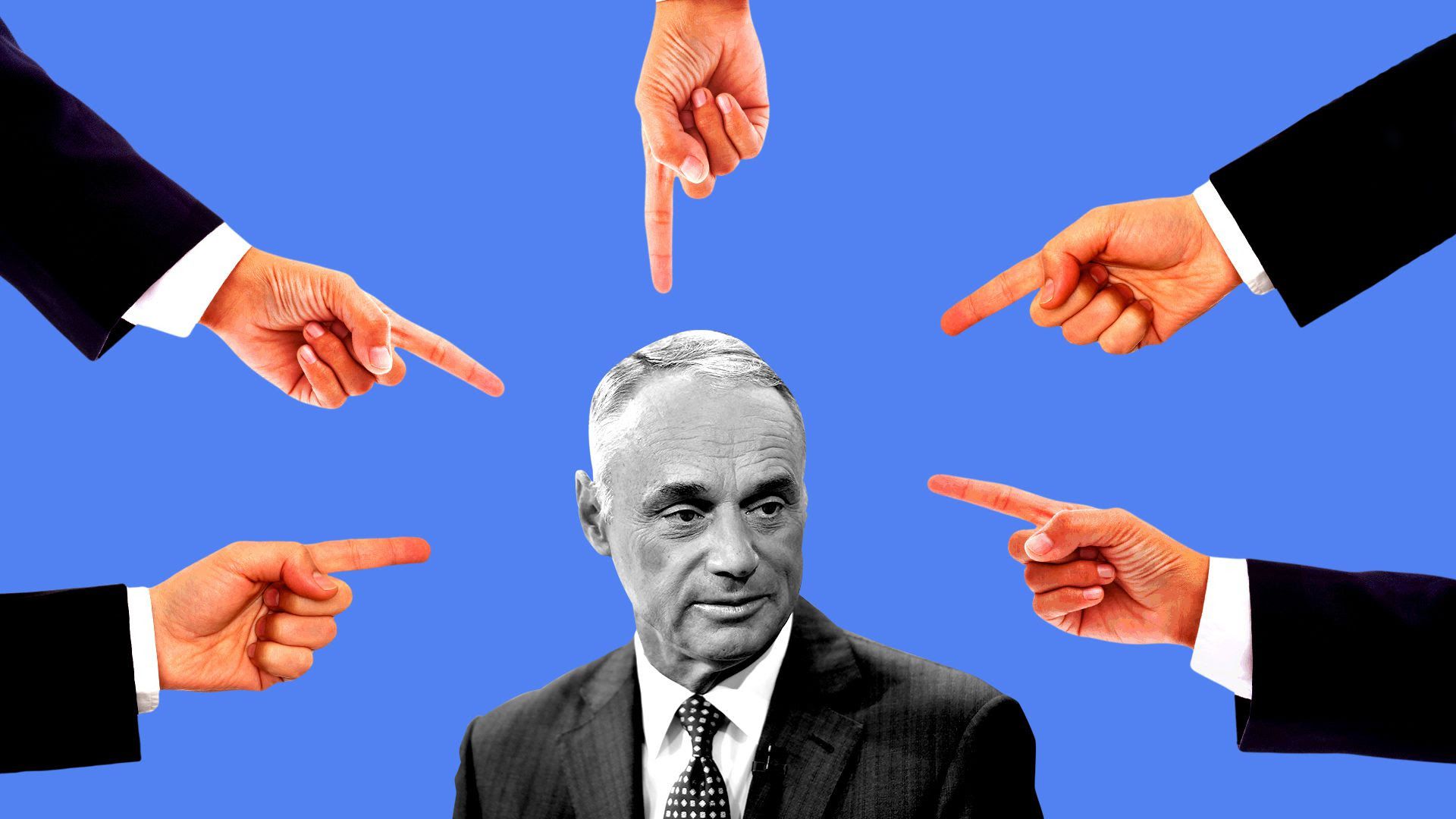MLB commissioner Rob Manfred surrounded by pointing fingers