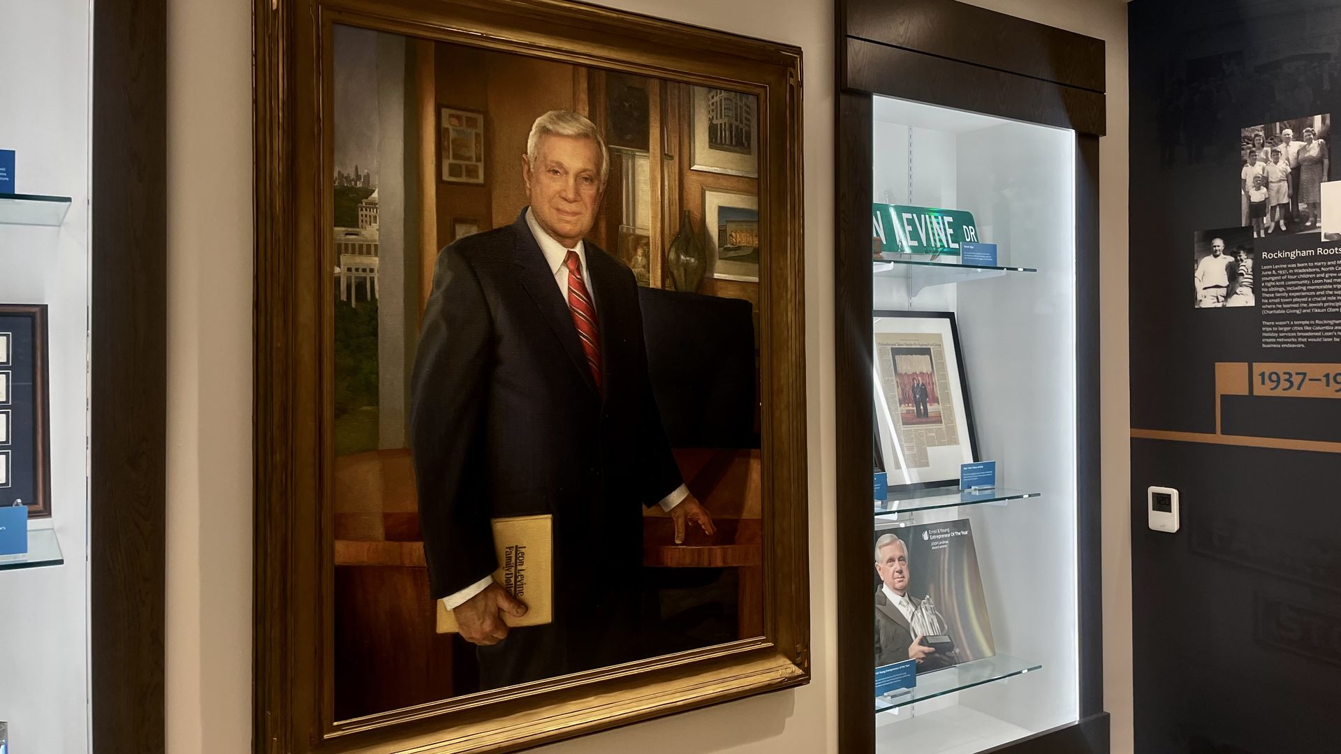 Portrait of Levine hangs from wall