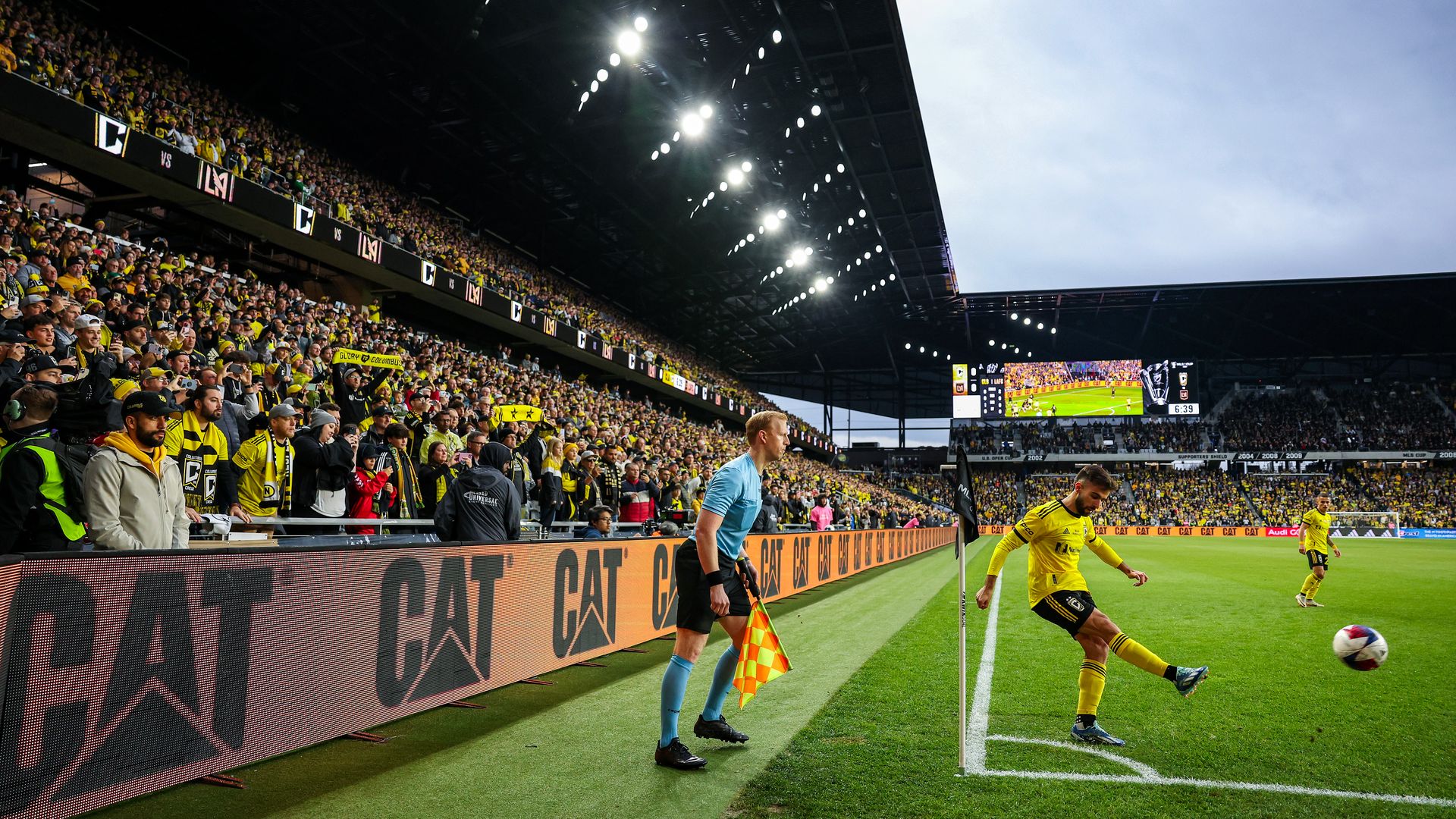 Columbus Crew player Diego Rossi takes a corner kick in front of fans
