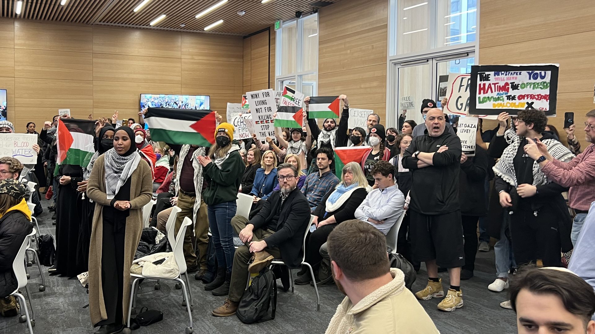 Demonstrators interrupt a Minneapolis City Council meeting with chants supporting a resolution calling for a ceasefire in Gaza. Photo by: Kyle Stokes/Axios