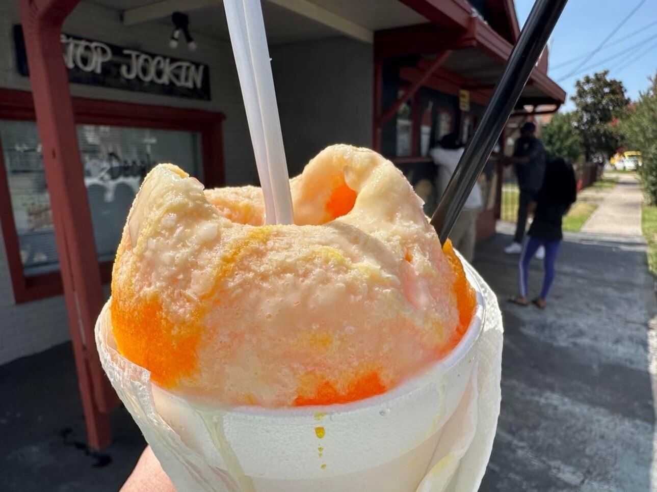 Photo shows an orange snoball with cream at Stop Jockin