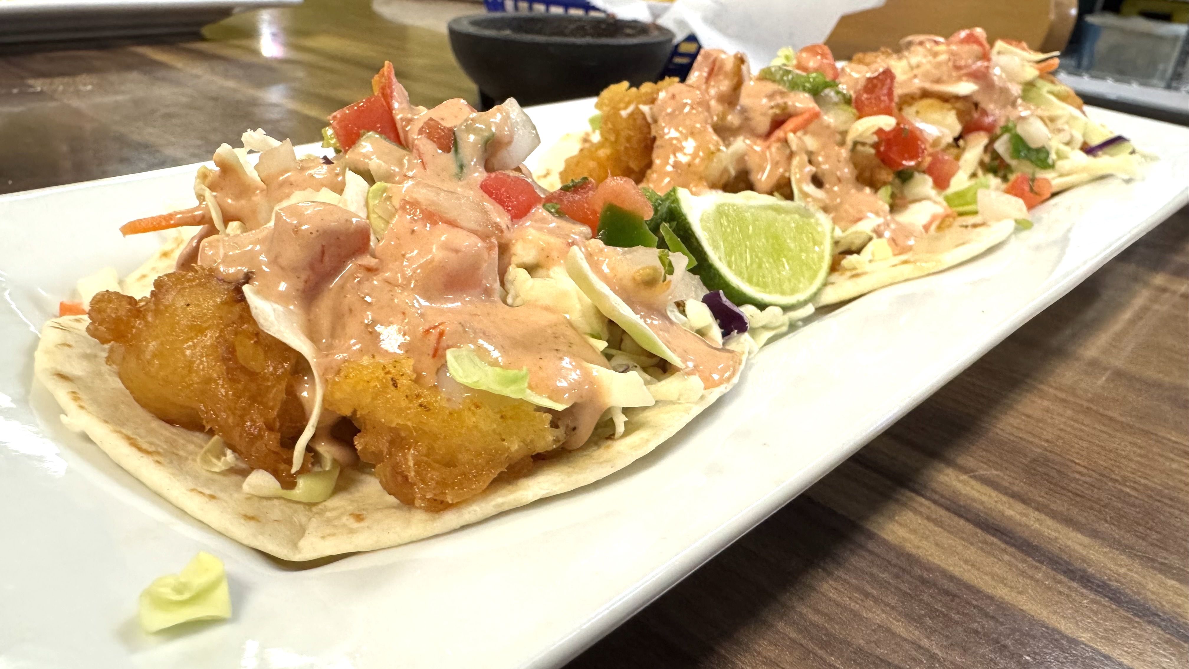 A plate of fried shrimp tacos.