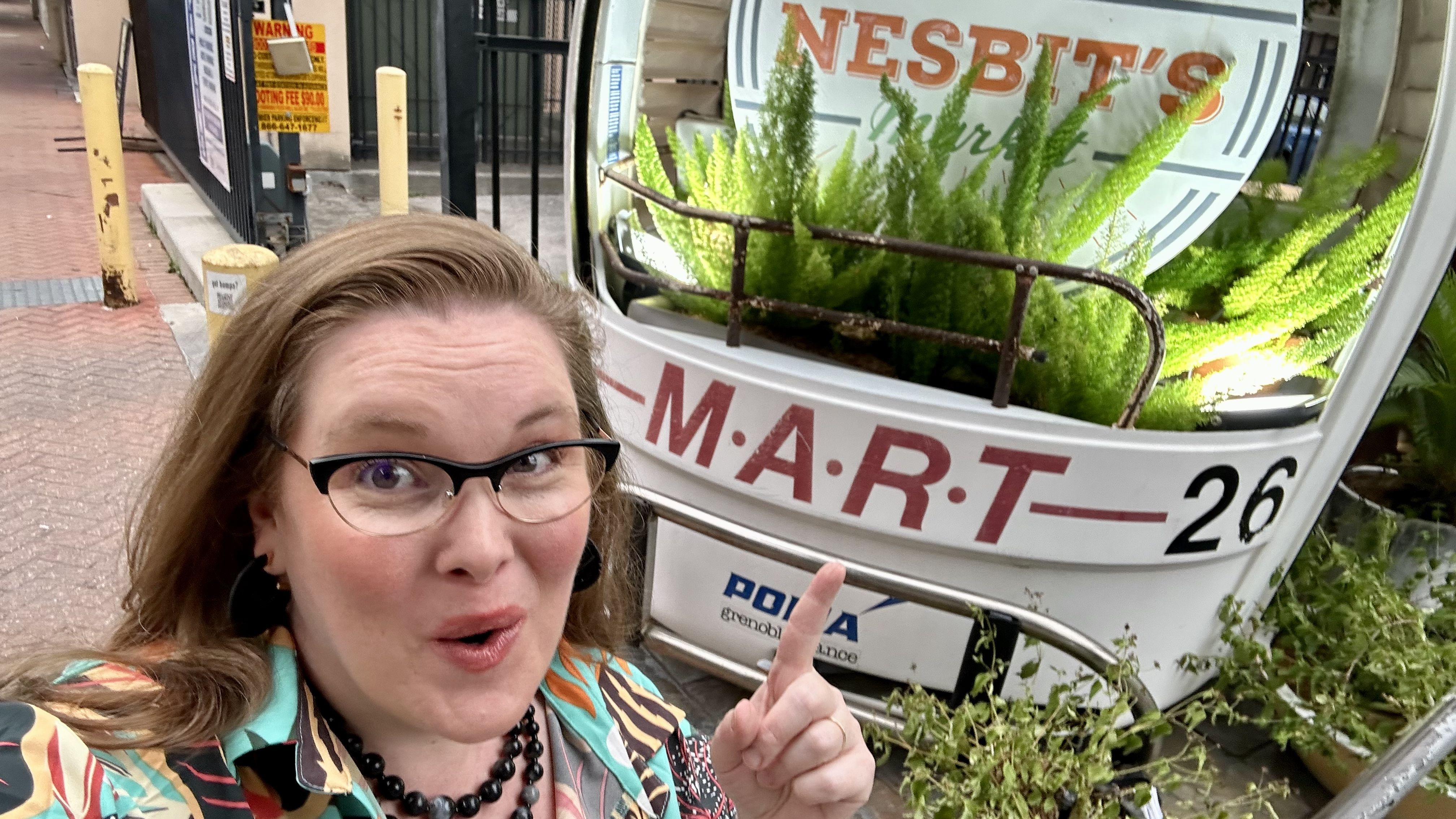 Photo shows Carlie making an excited face and pointing to the gondola.
