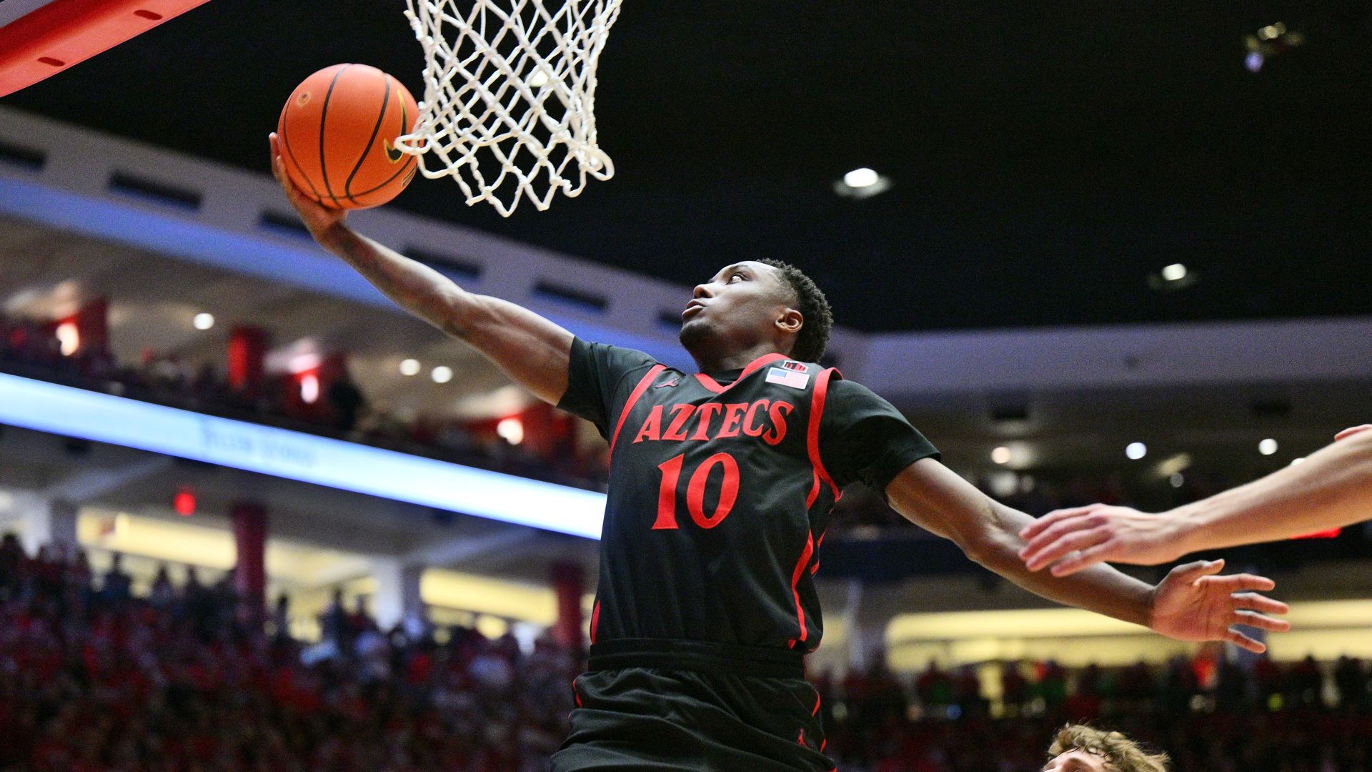 BJ Davis #10 of the San Diego State Aztecs men's basketball team reaches to score on a layup during a game. 