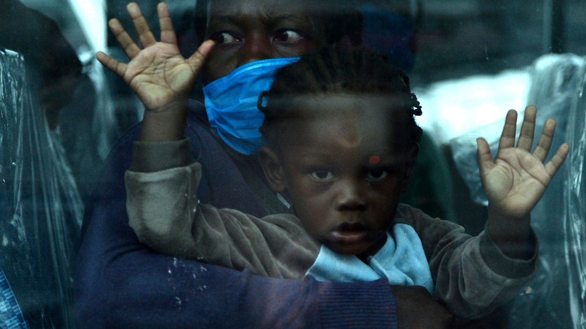 Photo of two migrants in a bus in Guatemala