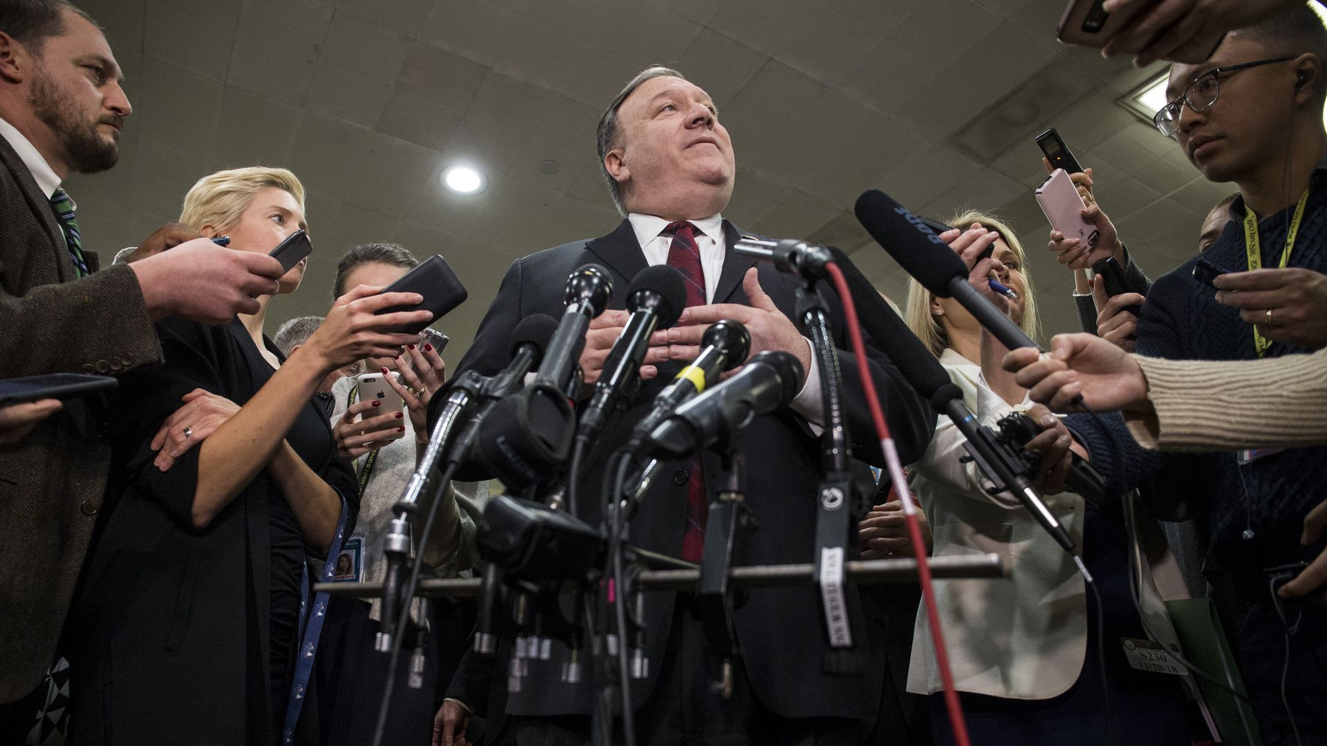 Mike Pompeo surrounded by media.