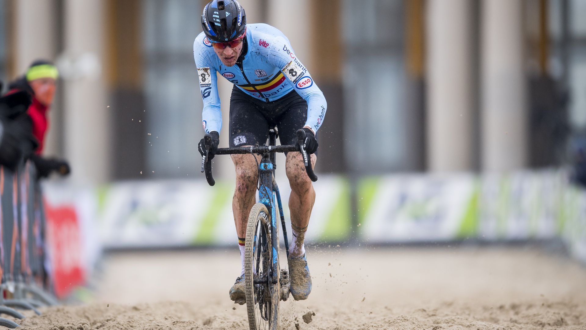 A man rides a bike through mud