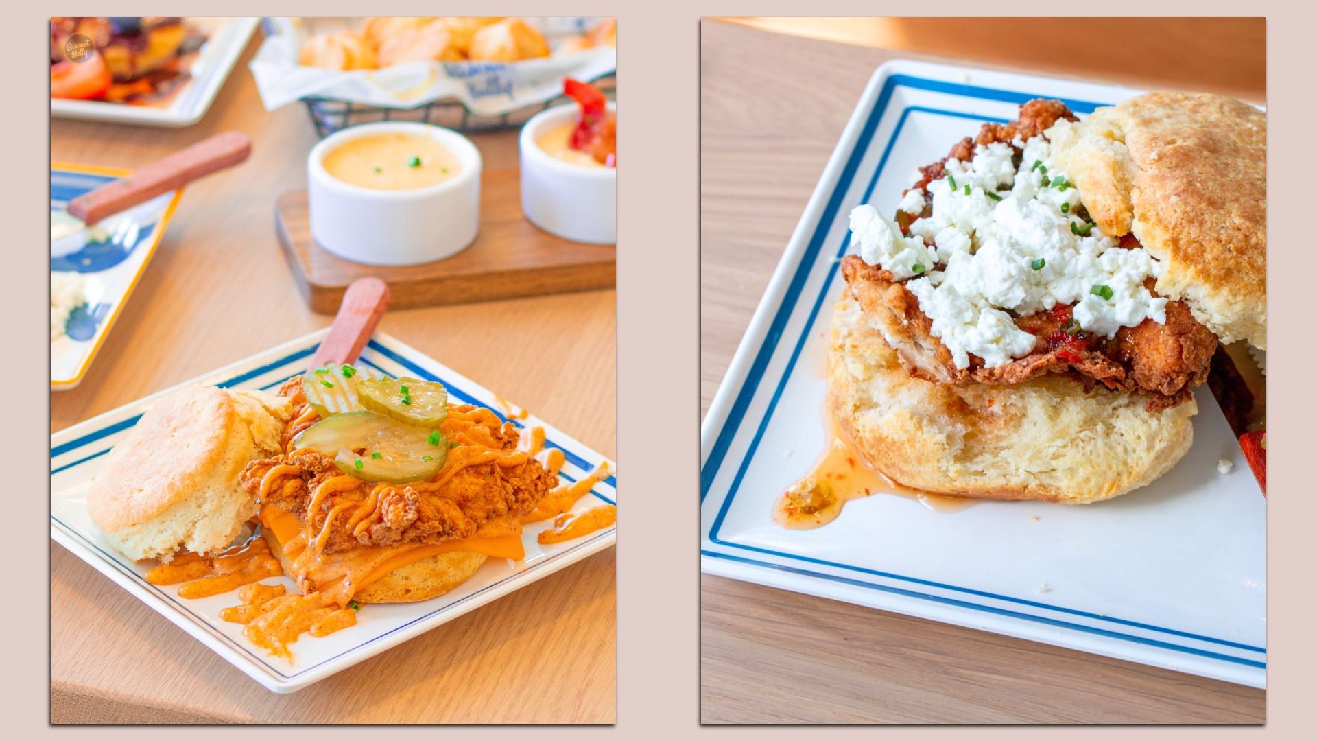 Two chicken sandwiches on a wood table: left has fried chicken with pickles and orange sauce on a bun, with dipping bowls; right shows a crispy sandwich topped with crumbled cheese and chives on a blue plate.
