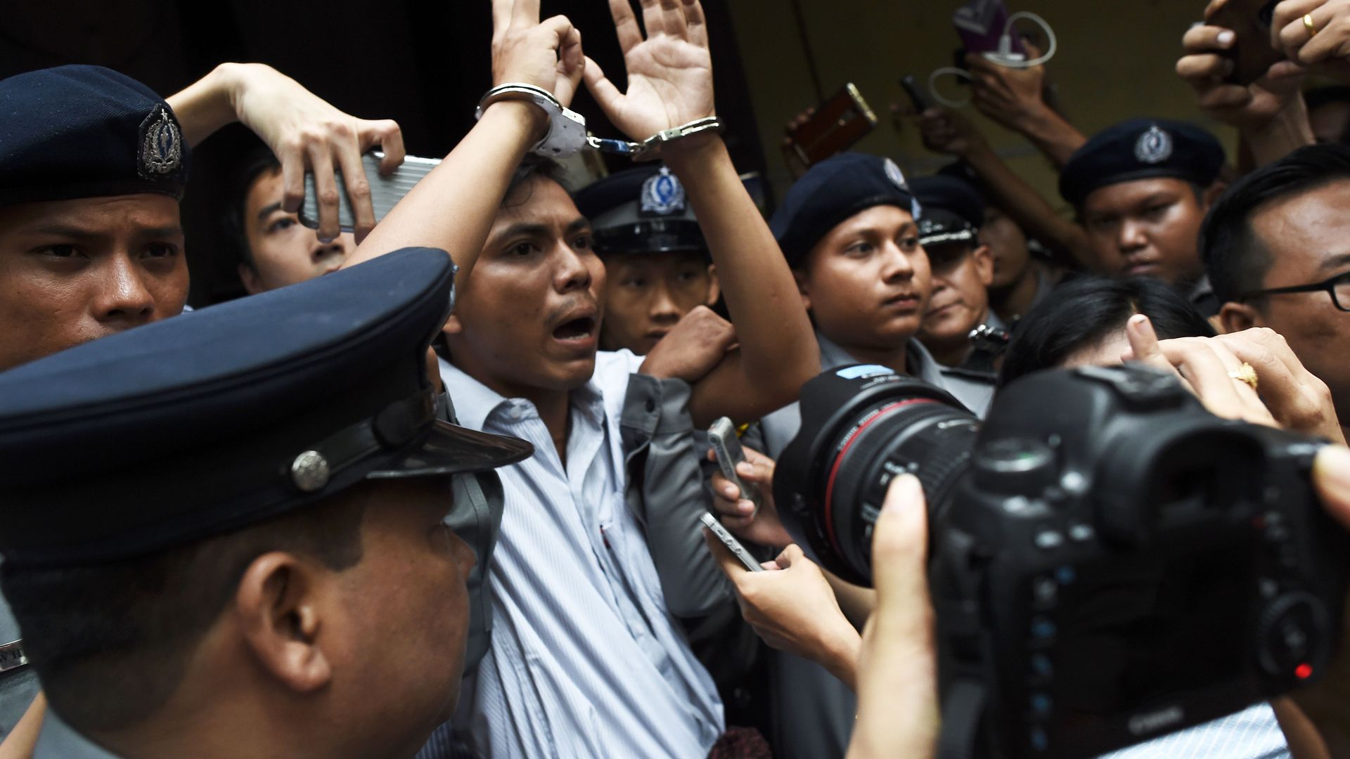 Reuters journalist Kyaw Soe Oo gets escorted by police after being sentenced to seven years in prison