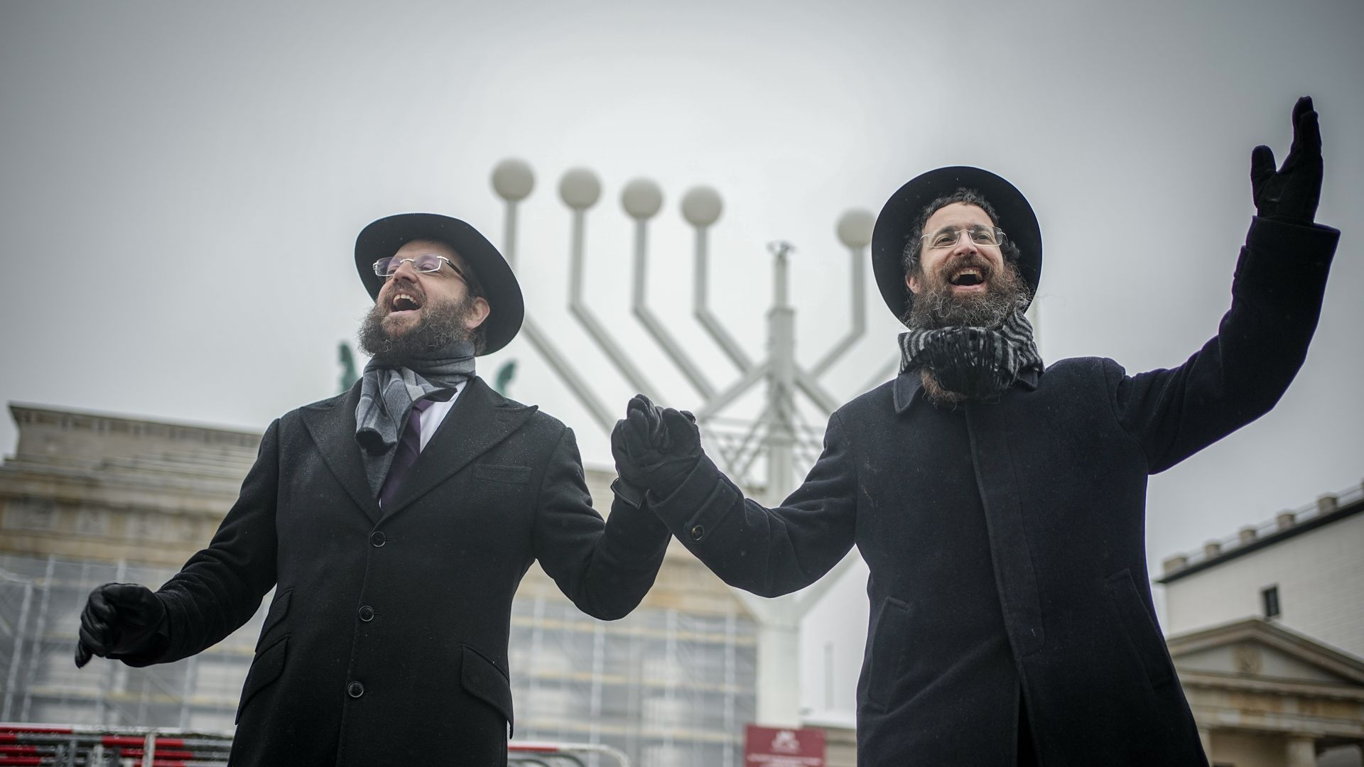 Yehuda Teichtal, Orthodox rabbi, and Rabbi Shmuel Segal dance after the inauguration of the Hanukkah candelabra at the Brandenburg Gate in Berlin..