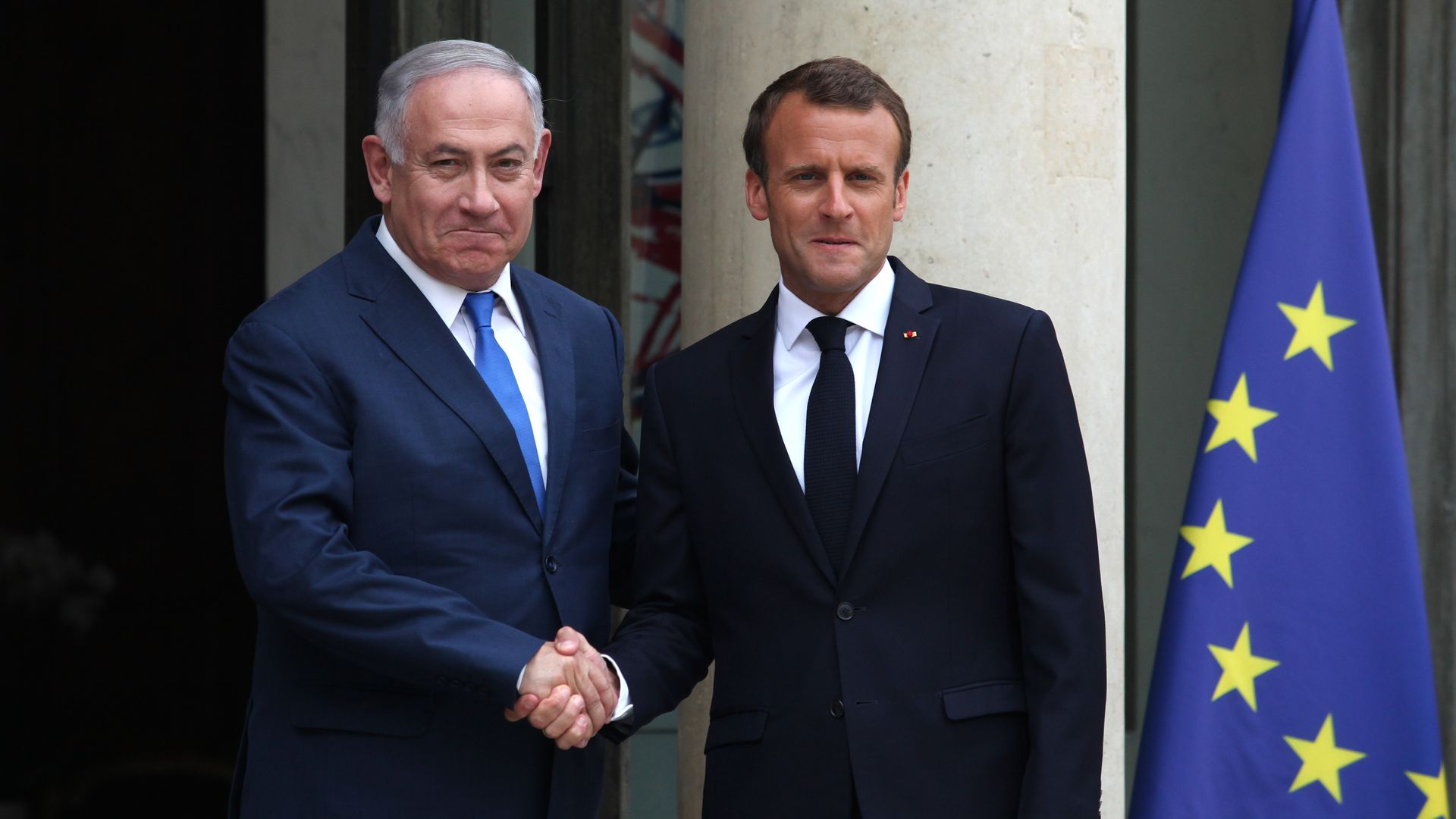 Israeli prime minister Benjamin Netanyahu shakes hands with French president Emmanuel Macron