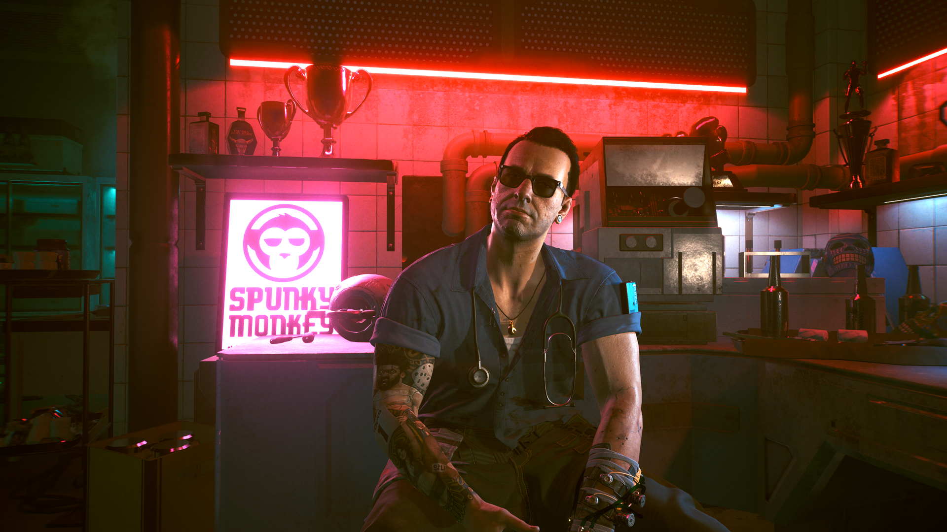 Video game screenshot of a man wearing sunglasses, sitting in a room glowing with a red light