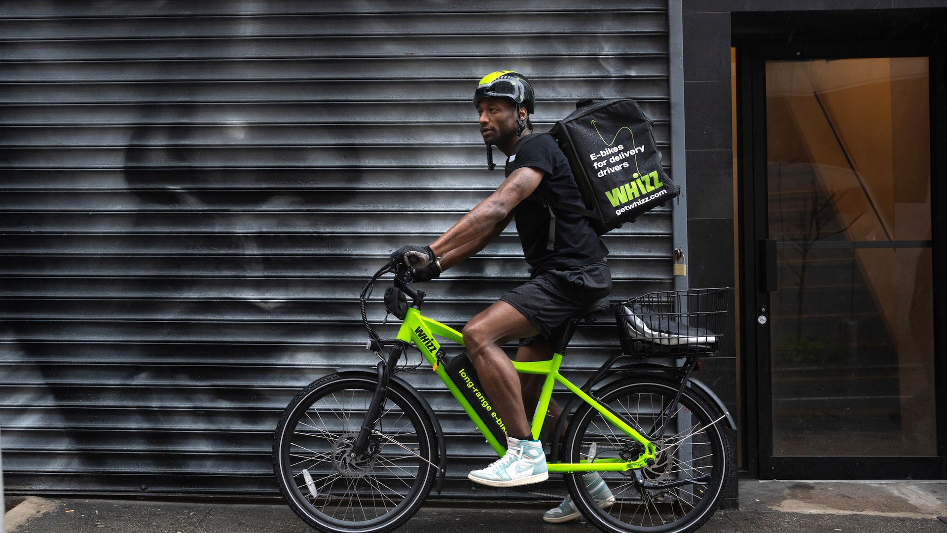 A neon green e-bike with a delivery rider 