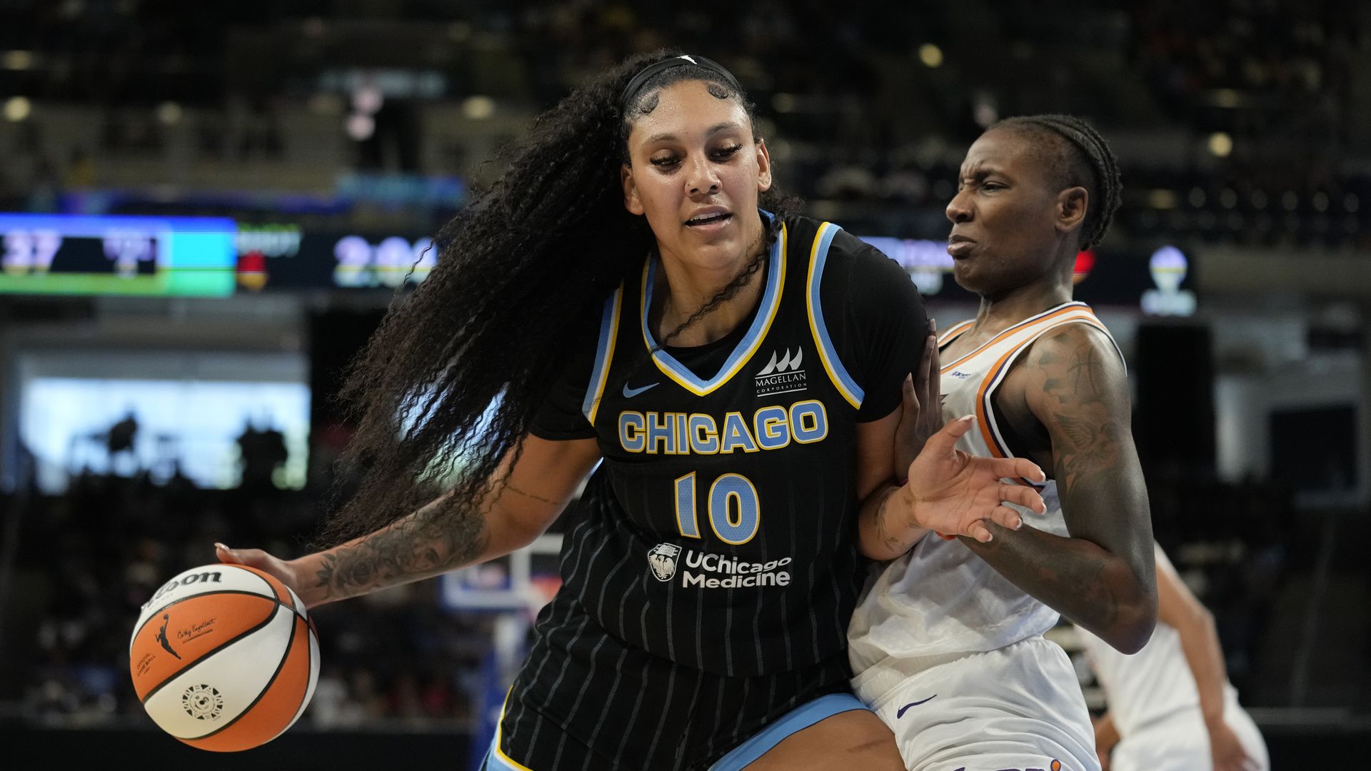 Photo of a woman playing basketball on a court. 