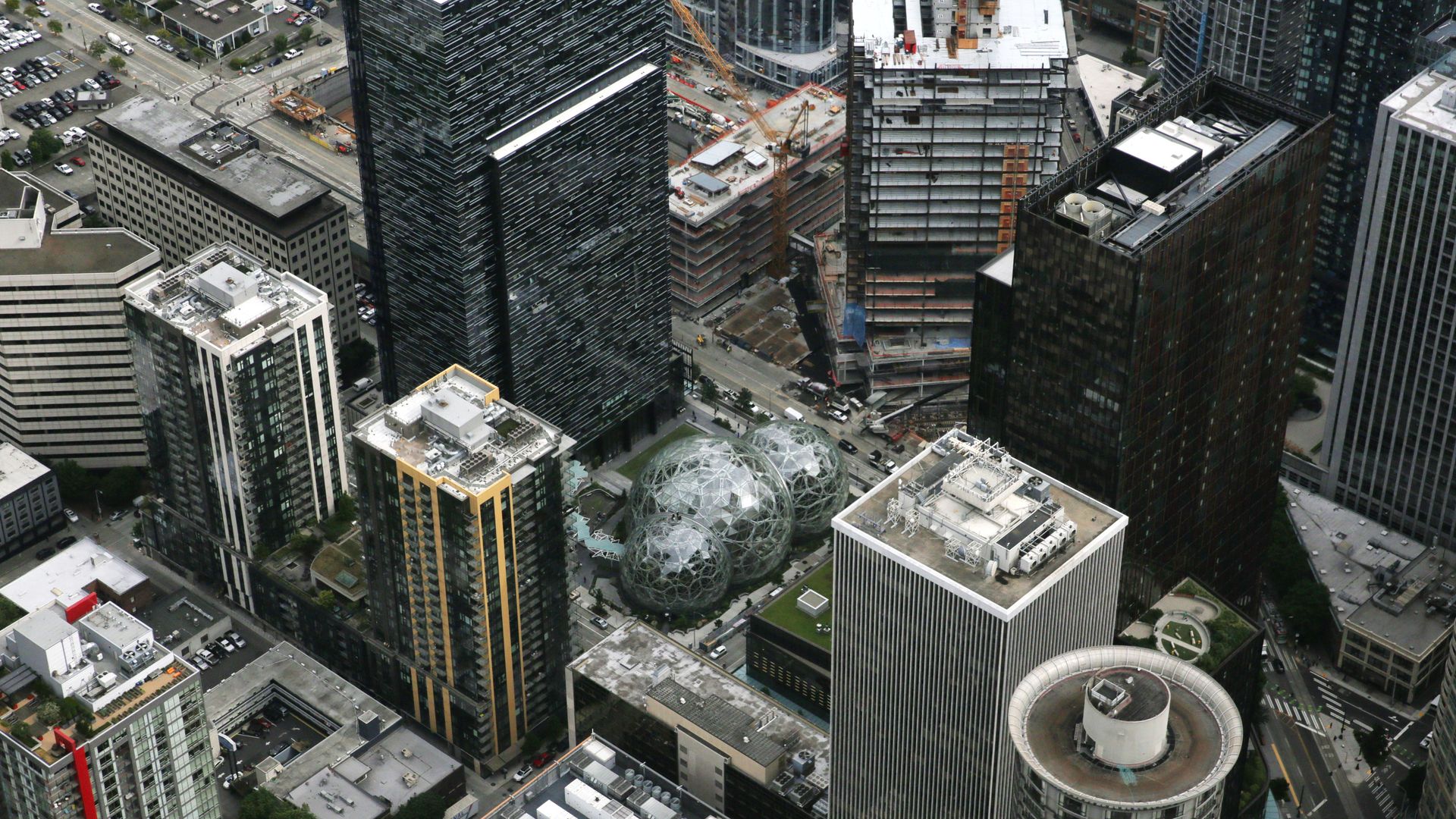 A bird's eye view of a cluster of Amazon buildings, including the Spheres, in Seattle. 