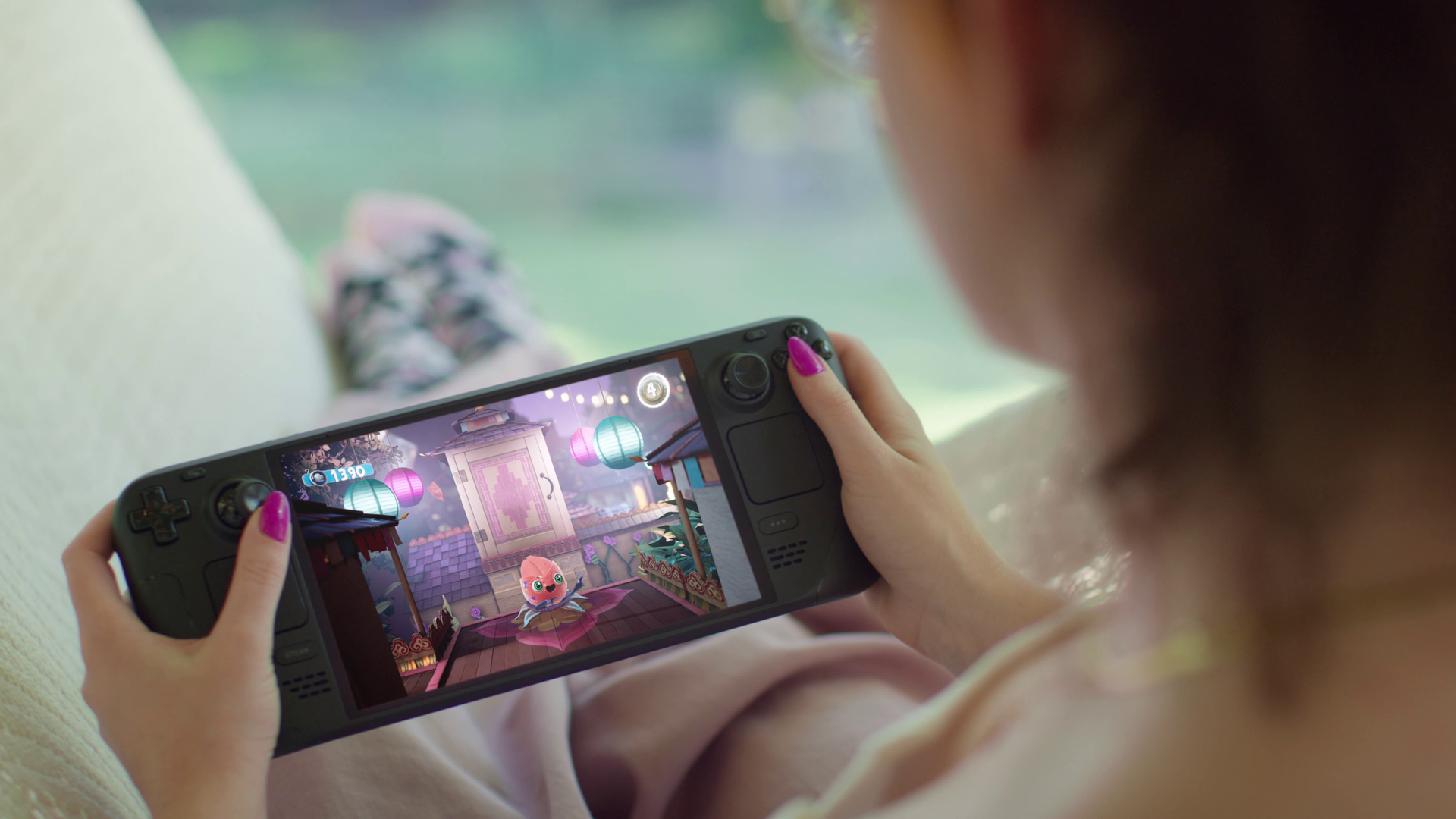 Photo of a person holding a Steam Deck OLED