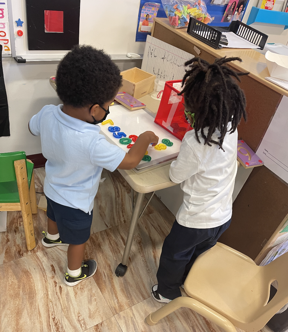 Two pre-k  3 students in their classroom.