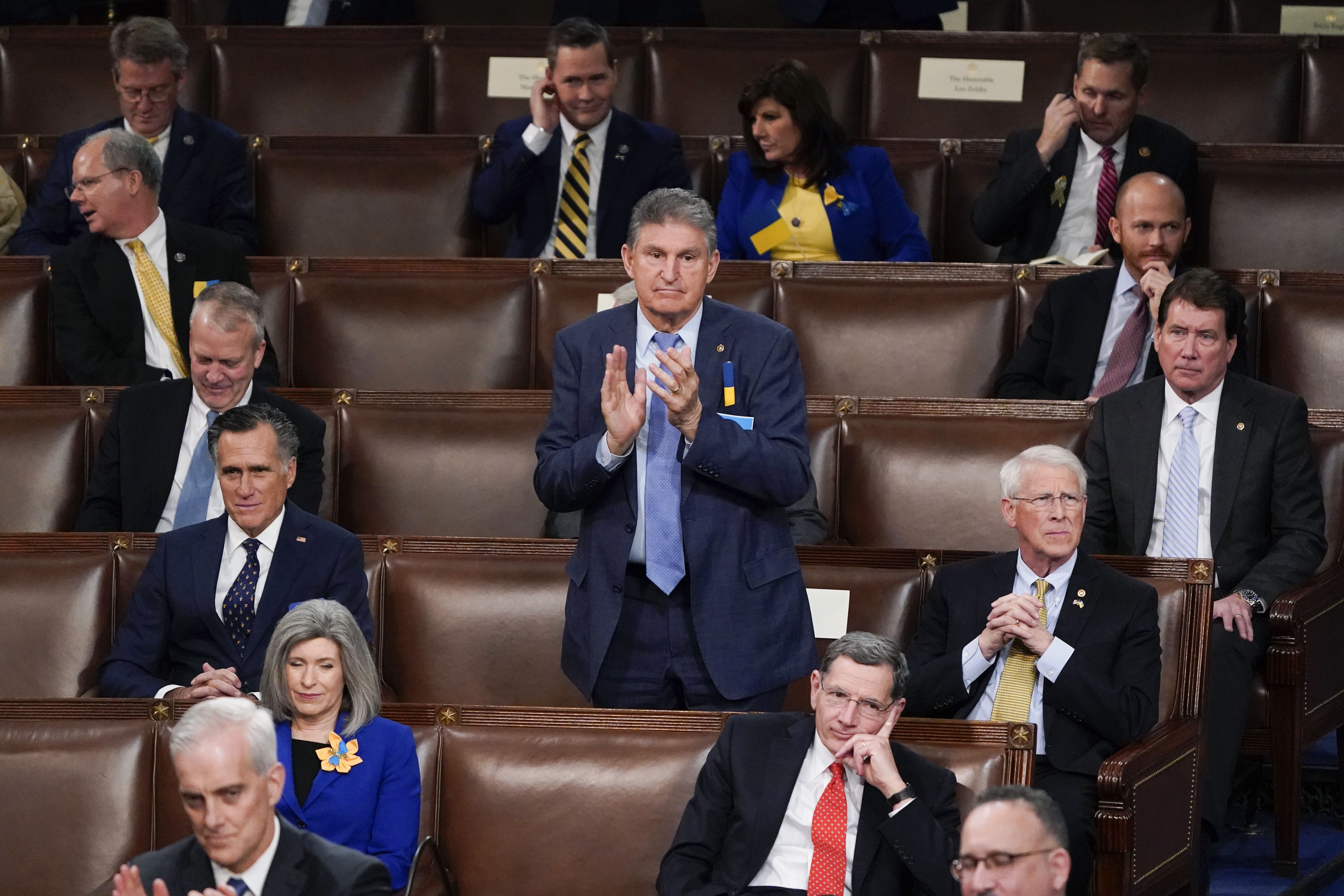 Sen. Joe Manchin sits with Republican senators at the State of the Union address.