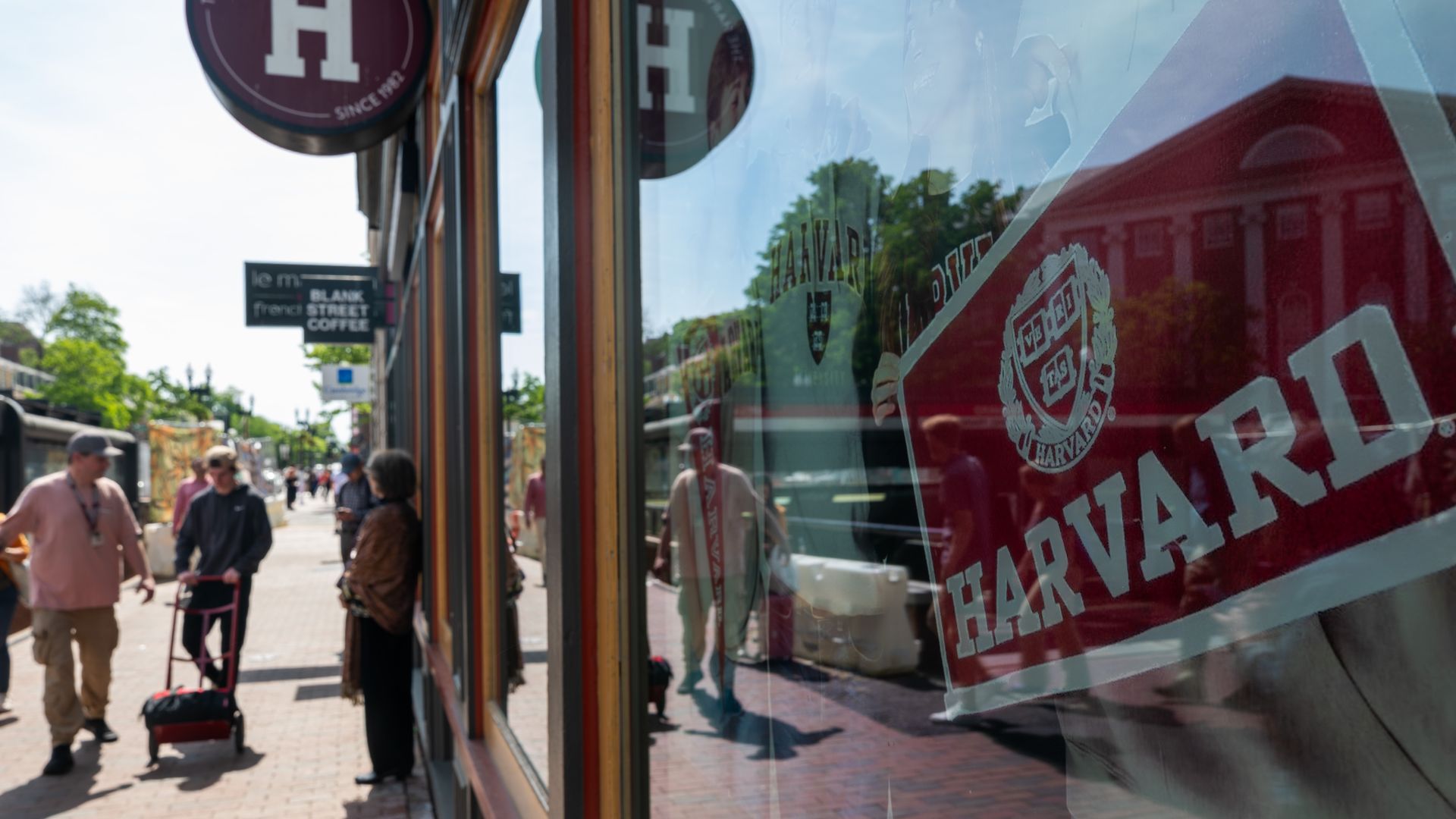 People walk past a Harvard building 