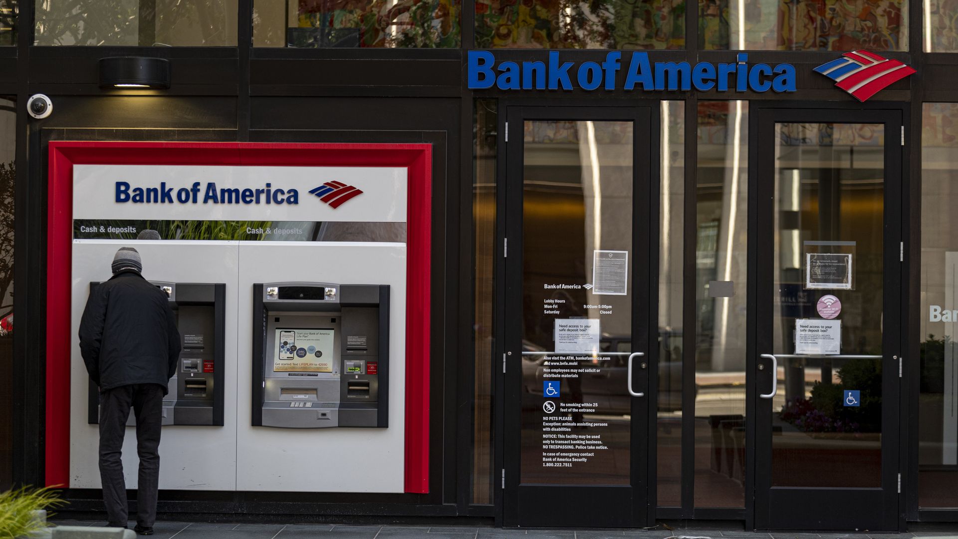 A person using an automated teller machine at a Bank of America bank branch in San Francisco in April 2021.