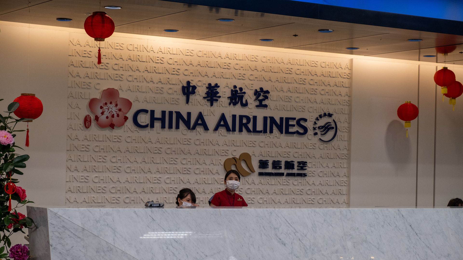 China Airlines staff wear respirator masks in Taipei airport on Jan 22, 2020