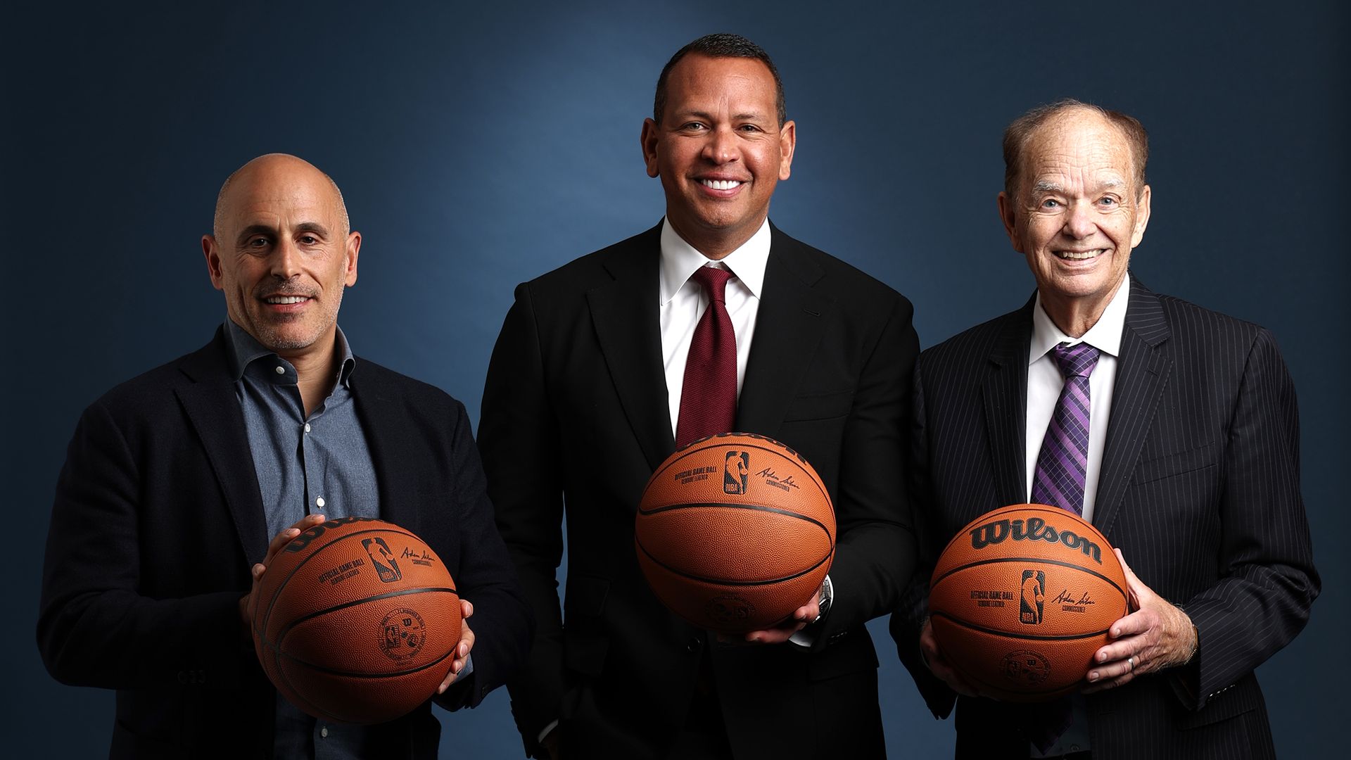Marc Lore, Alex Rodriguez and Glen Taylor holding basketballs 