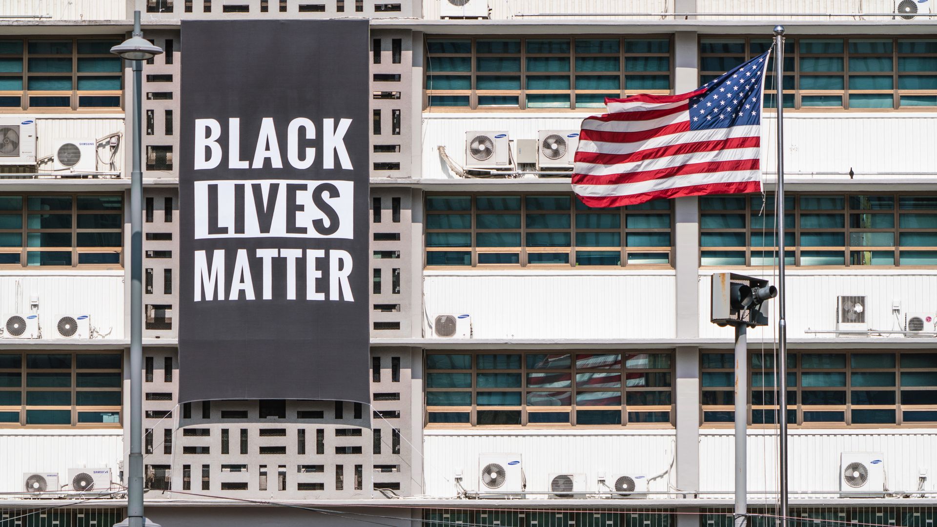 The American flag next to a "Black Lives Matter" sign.