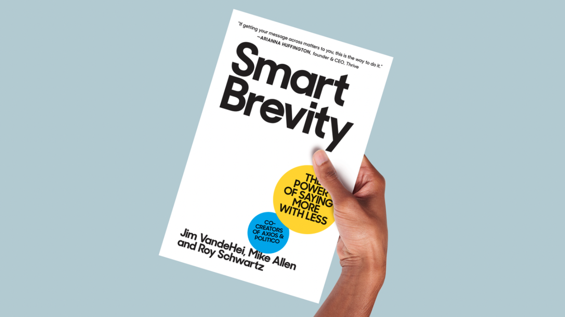 A hand holding a book that says "Smart Brevity"