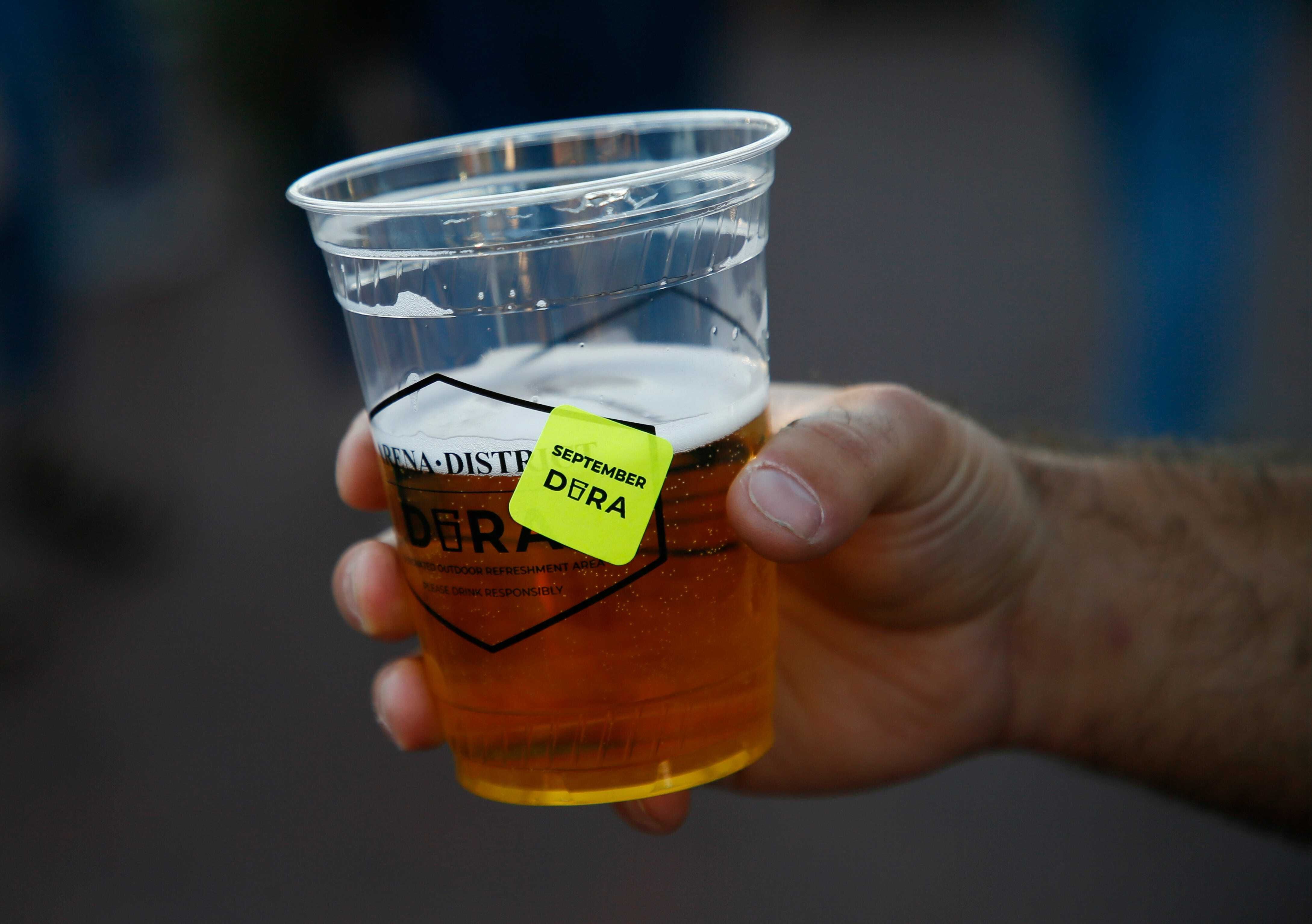 cup of beer with a label that reads DORA