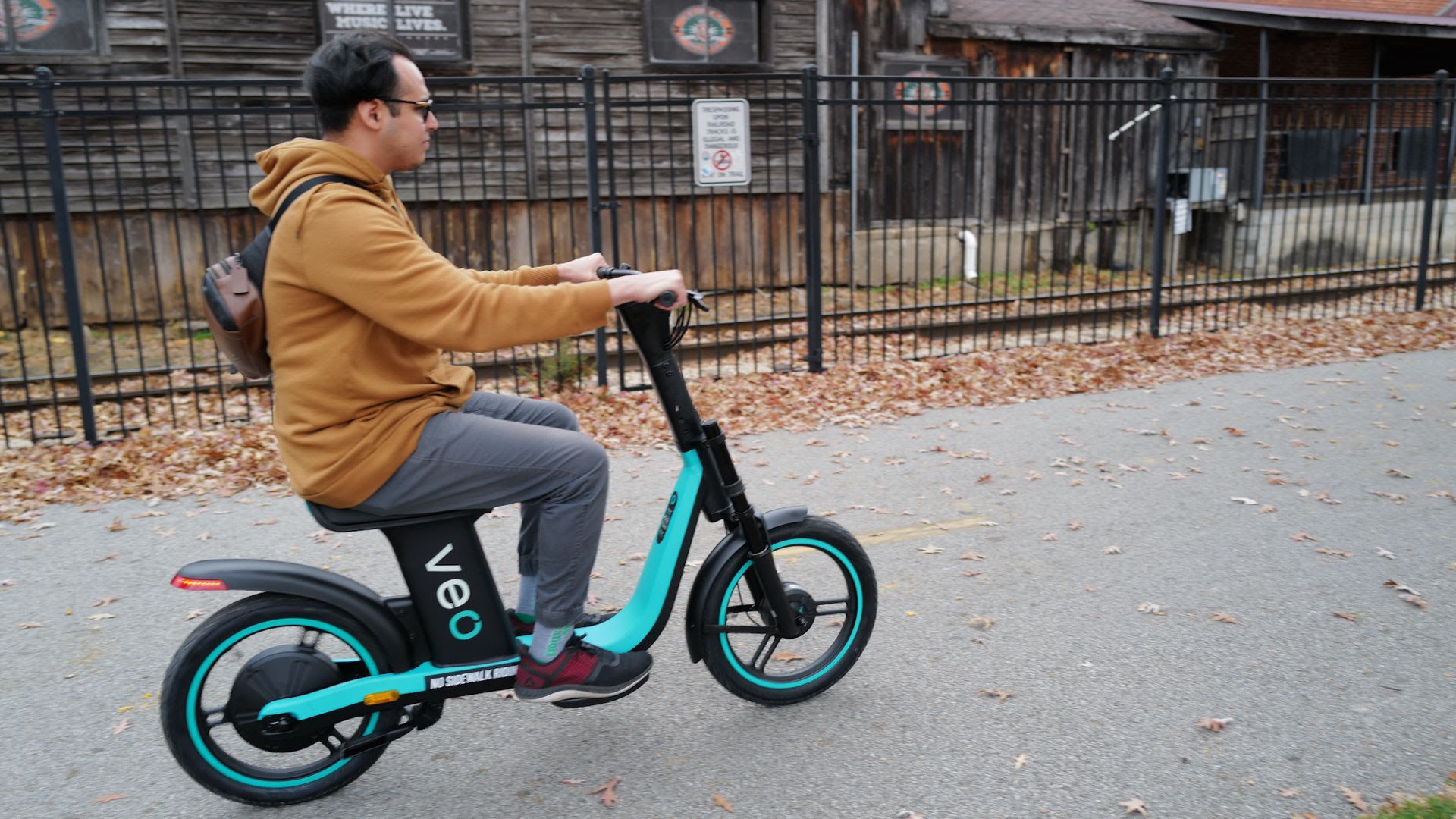 Nue Villanueva tries out Veo's seated scooter on the Razorback Regional Greenway in Fayetteville at a demo day in December.
