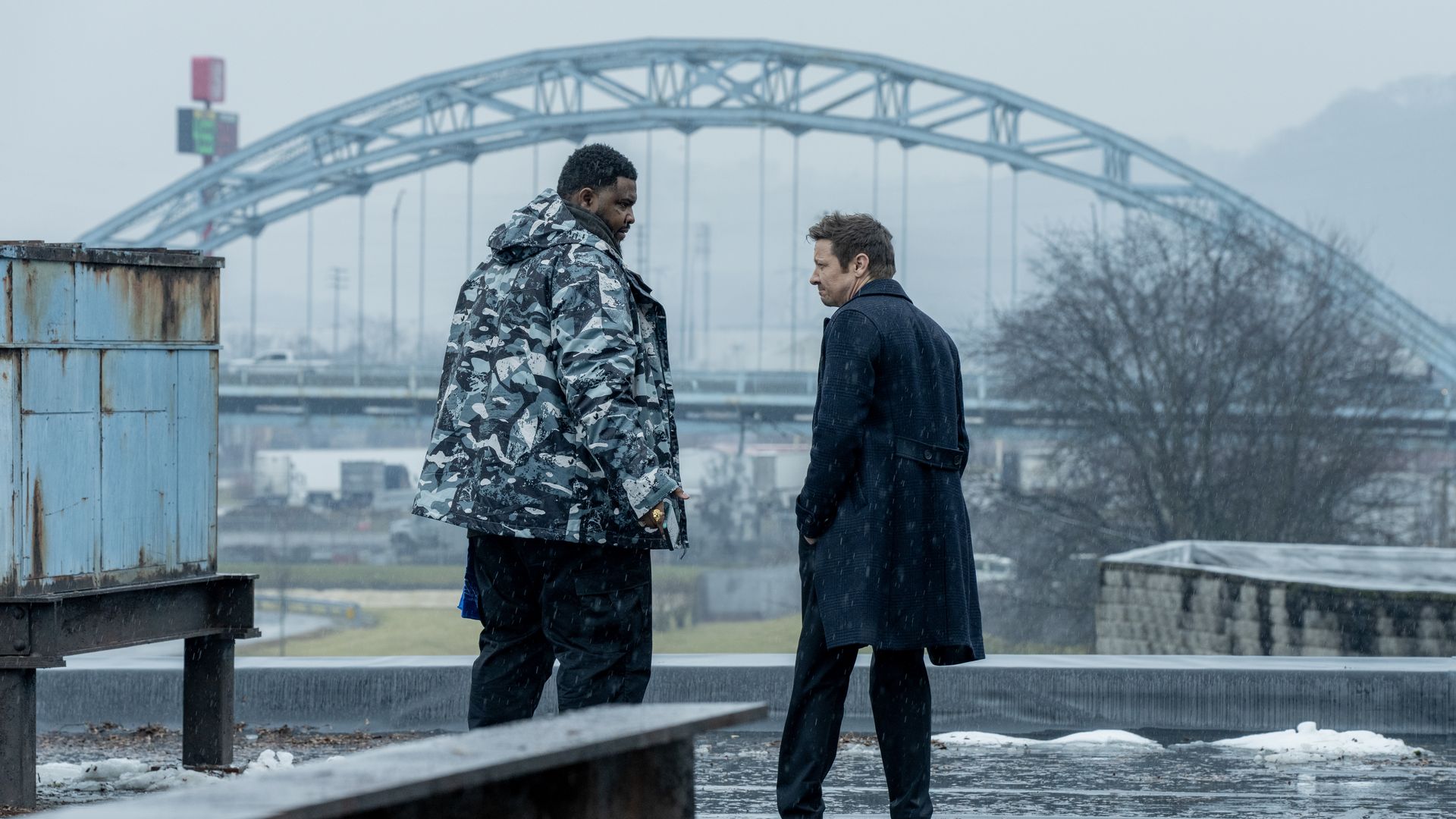 Actors Tobi Bamtefa and Jeremy Renner stand together during a scene in "Mayor of Kingstown."