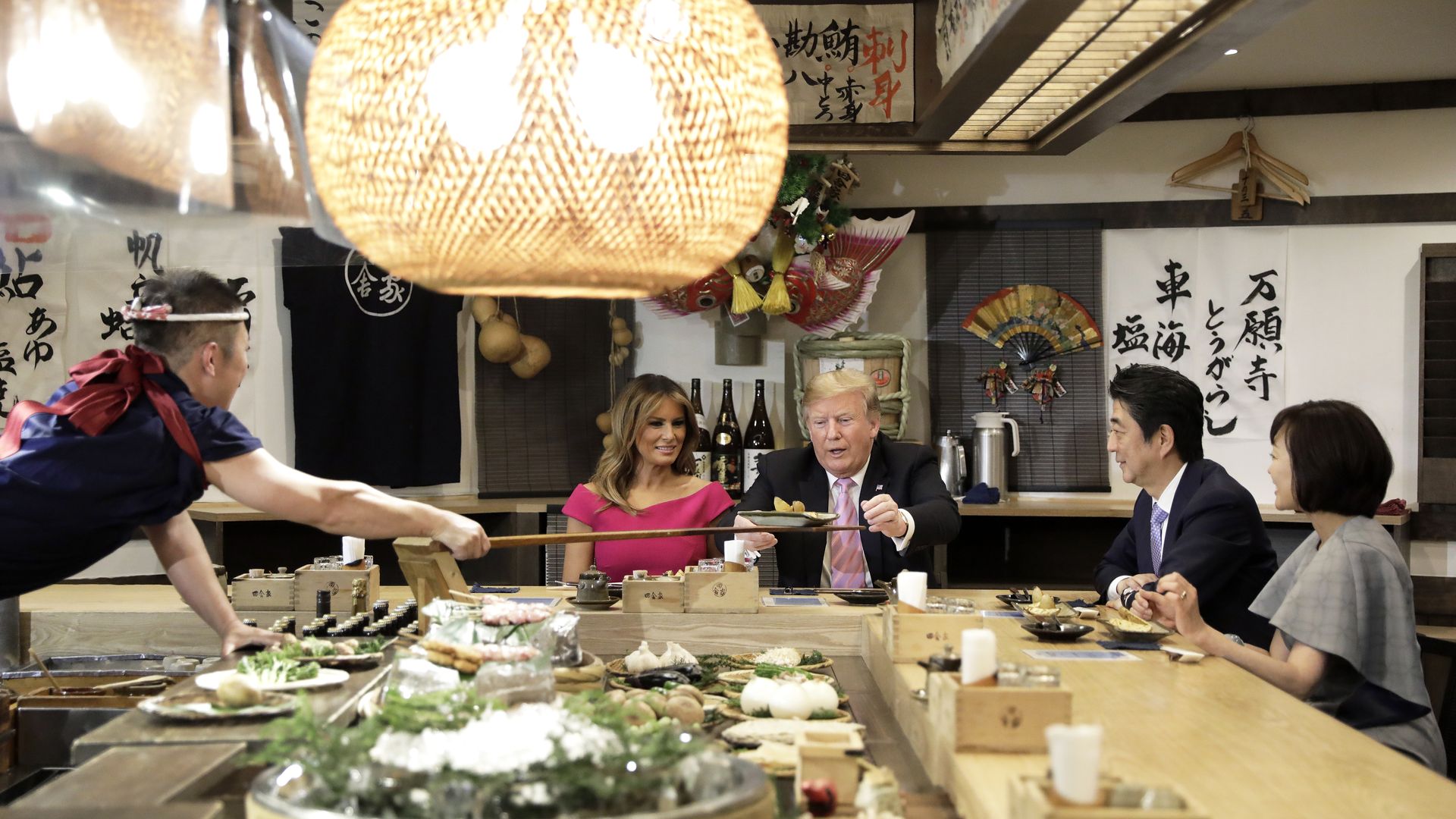 President Trump is served a baked potato with butter in Tokyo, while dining with Melania Trump, Prime Minister Shinzo Abe and his wife, Akie Abe. (Photo: Kiyoshi Ota/Pool/Getty)