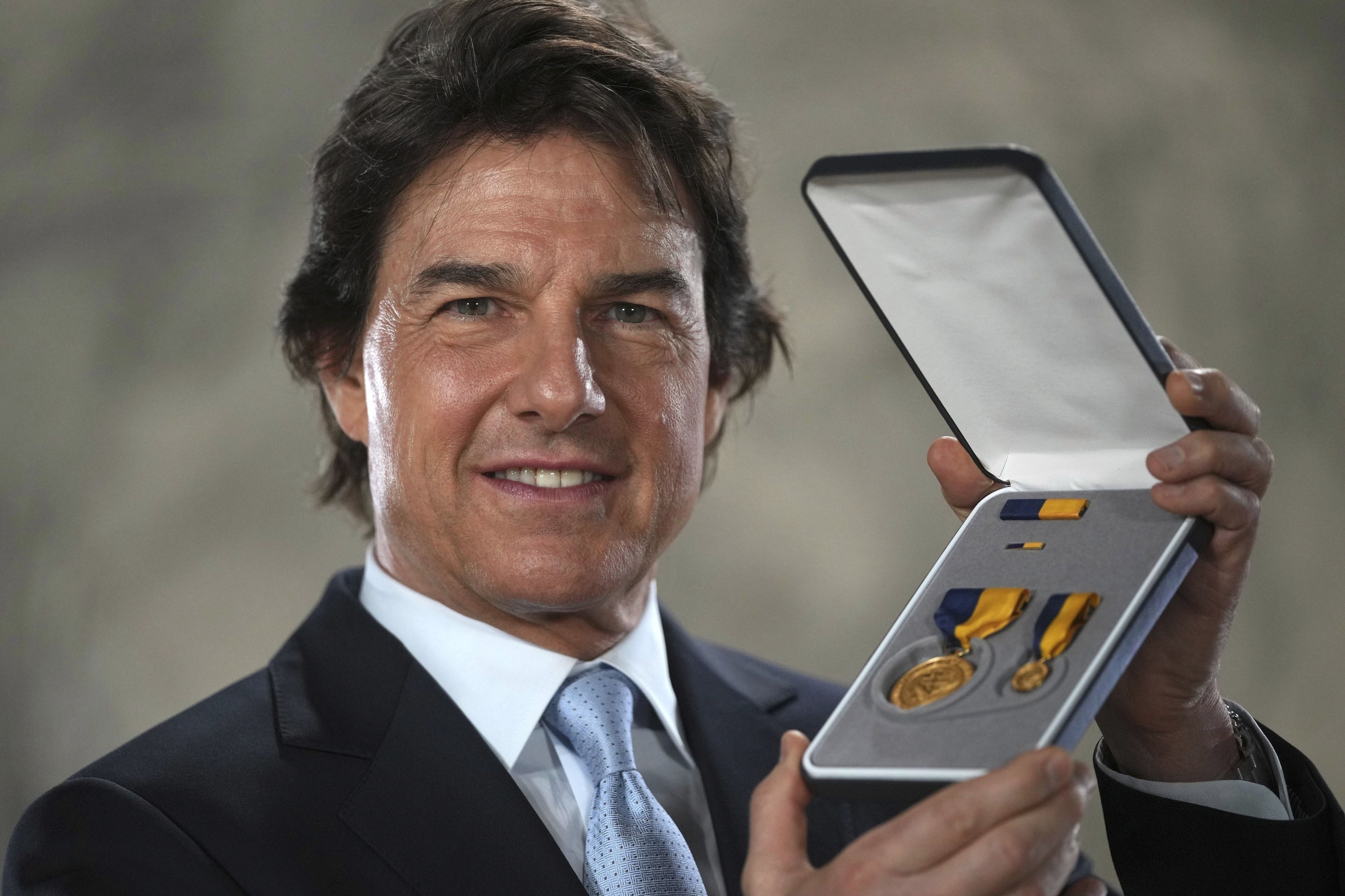  Tom Cruise receives a Navy Distinguished Public Service Award from The United States Secretary of the Navy Carlos Del Toro presents at the Longcross South Studios, in Runnymede, Surrey, England, Tuesday, Dec. 17, 2024. (AP Photo/Kin Cheung)