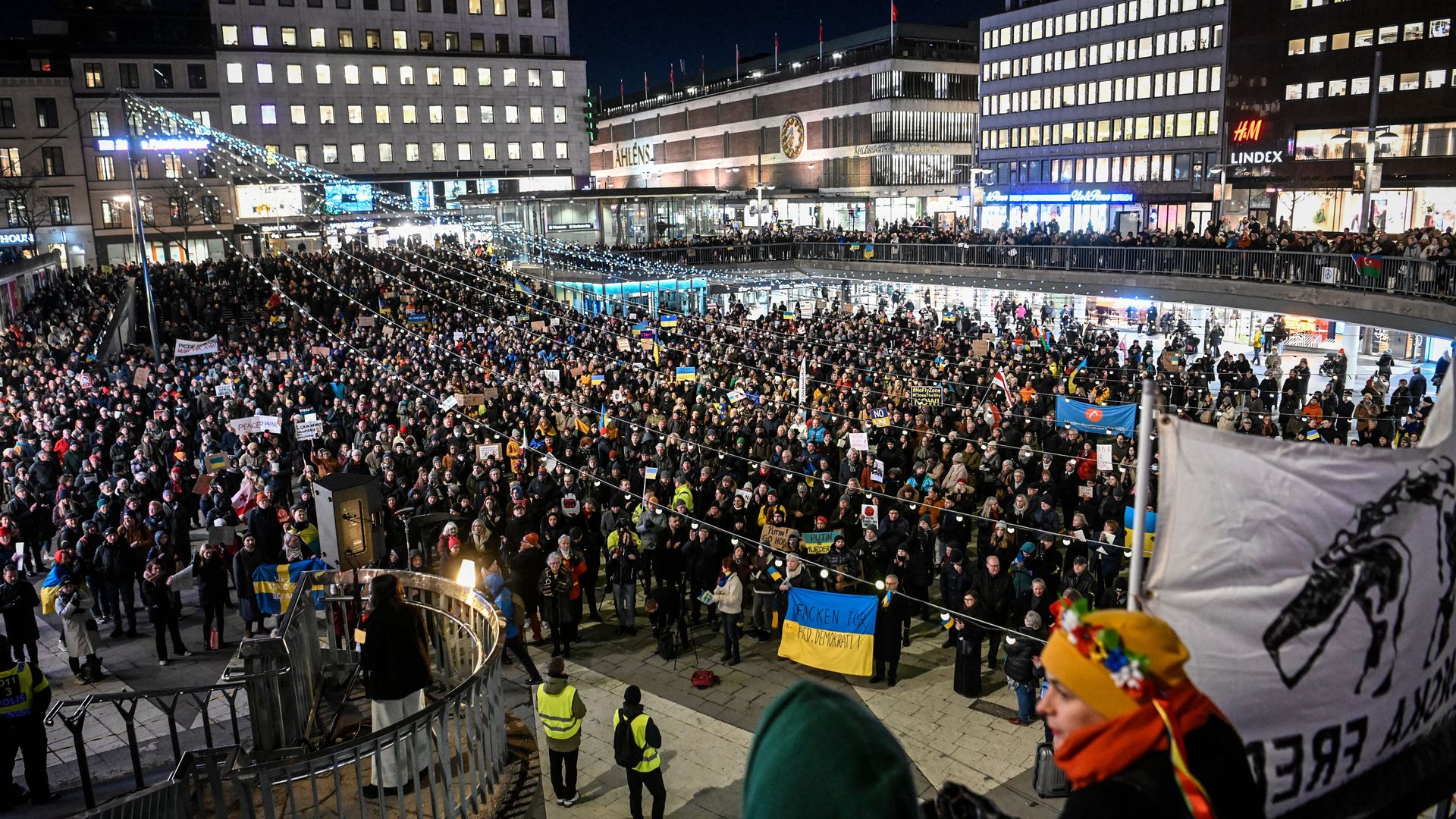 Protesters hold Ukrainian placards and banners during a demonstration to protest against the Russian invasion of Ukraine, at Sergel's Square