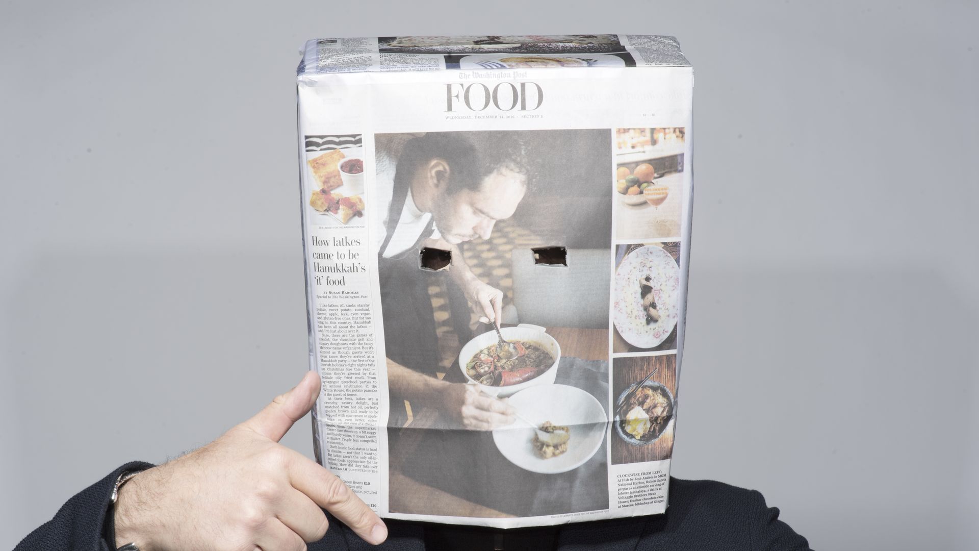 Tom Sietsema poses with a print newspaper box over his head to shield his identity