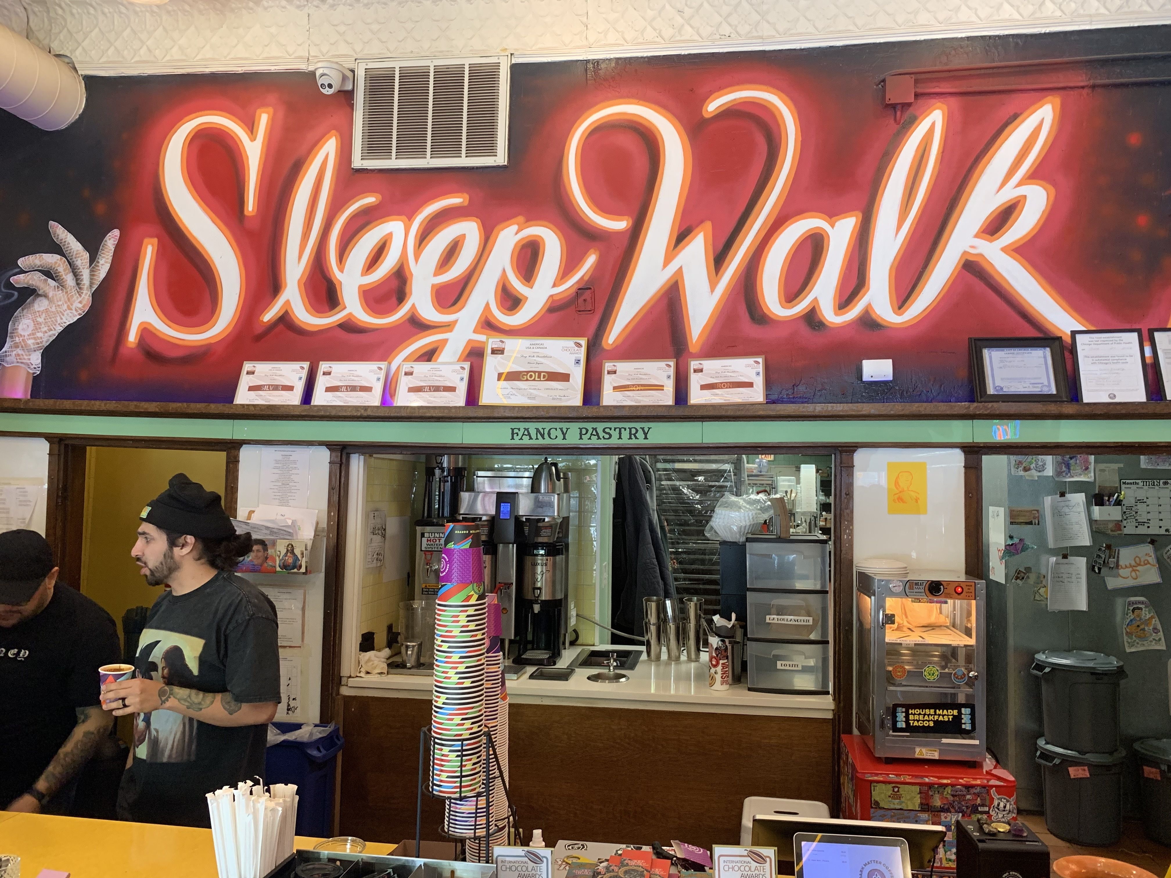 Photo of a coffee shop with a sign that says Sleep Walk. 