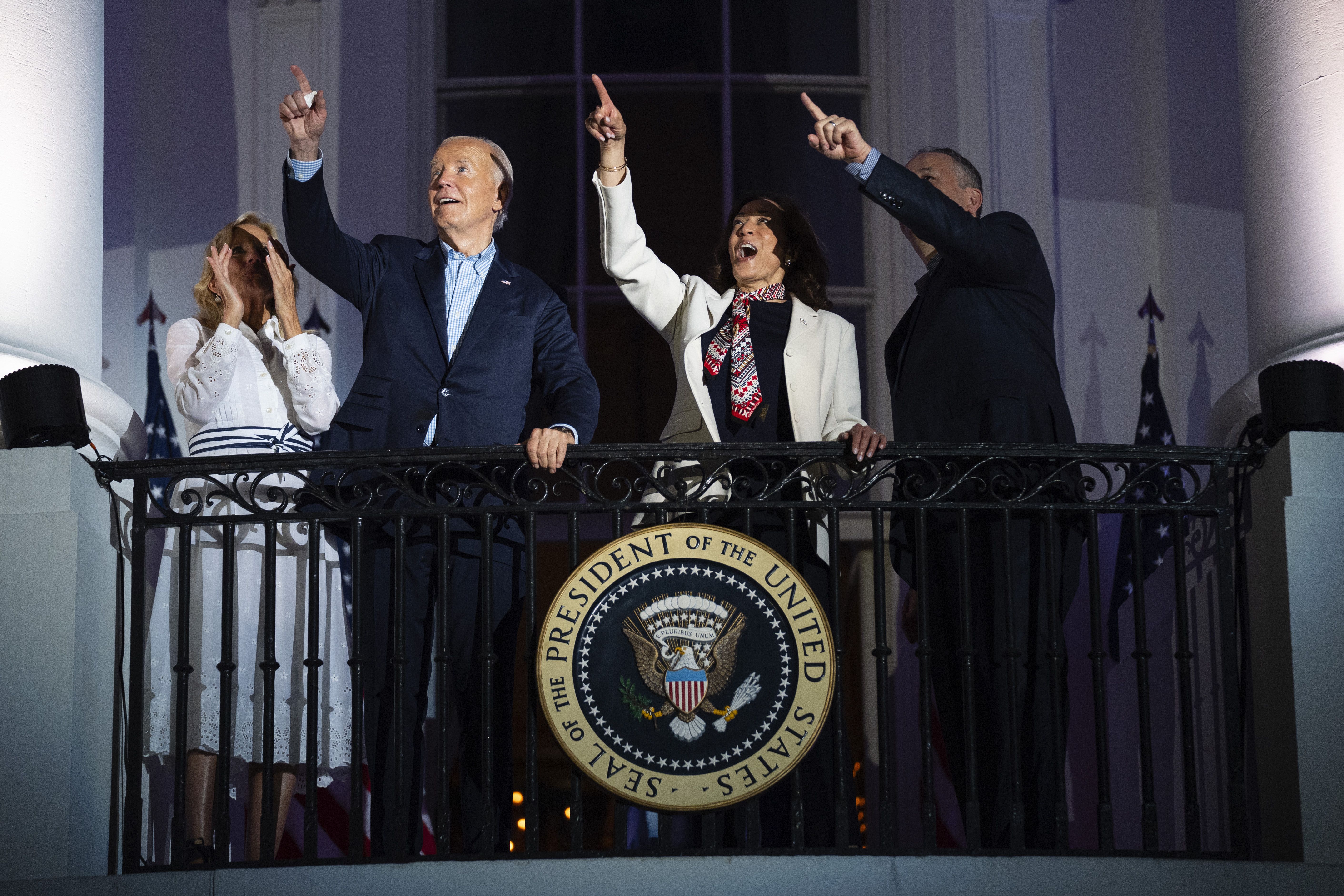 First lady Jill Biden, President Joe Biden, Vice President Kamala Harris, and second gentleman Douglas Emhoff view the Independence Day firework display over the National Mall from the balcony of the White House
